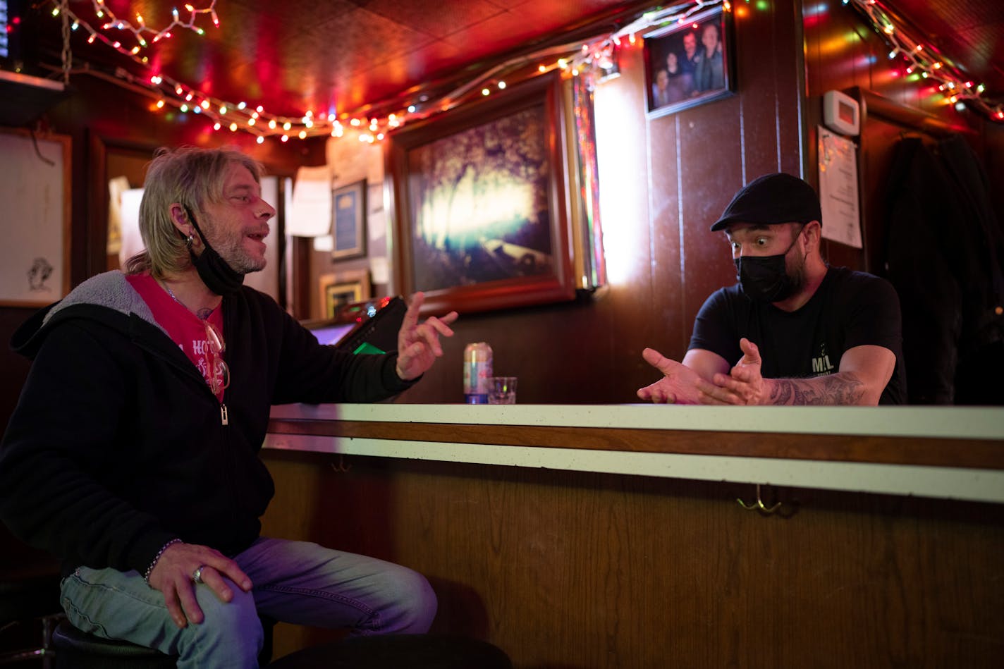 Brent Hanson and bartender Justin Fowler visited at Dusty's Bar Thursday, Jan. 6, 2022 a few minutes before the mask mandate went into effect in Minneapolis, Minn. Minneapolis and St. Paul were back under a mask mandate beginning at 5 p.m. Thursday. The new order began quietly at Dusty's Bar in Northeast Minneapolis. ] JEFF WHEELER • Jeff.Wheeler@startribune.com