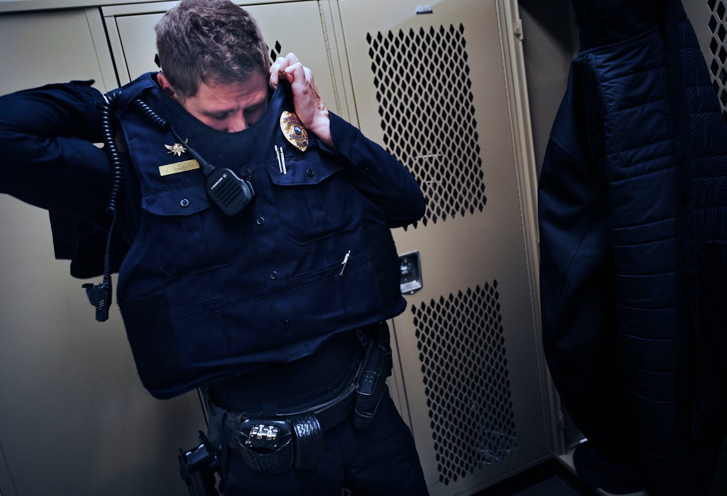 Sgt. Joe Adams of the Roseville Police put on his uniform to start his 6PM to 6AM shift. He found himself in an intractable position of having to neutralize Wayne Malone when he brandished a fake gun outside his apartment.] Richard Tsong-Taatarii/rtsong-taatarii@startribune.com