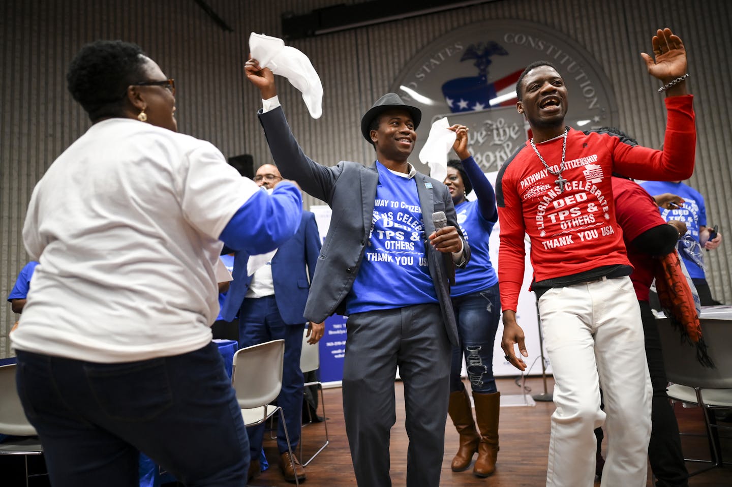 Brooklyn Center Mayor Mike Elliott, the first Liberian and person of color to be mayor of the city, was joined by jubilant members of the local Liberian community who were waving white flags for victory at Saturday afternoon's event for DED/TPS recipients from Liberia who recently won a path to permanent residency in the U.S. Aaron Lavinsky • aaron.lavinsky@startribune.com