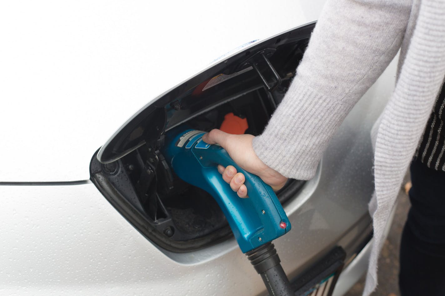 Rhea O'Connor removes the nosel of the Fast Charger after charging her Nissan Leaf, an electric car, at a BP off of Lyndale Ave. S, is the only service station in the state that has a Fast Charger, which can charge to 80 percent in 20 minutes. ] Elizabeth Brumley special to the Star Tribune * Minnesota legislators are debating possible tax rebates for those who buy new electric or hybrid vehicles. The proposal is being led by Rep. Pat Garofalo, who owns a high-performance, all-electric Tesla. Th