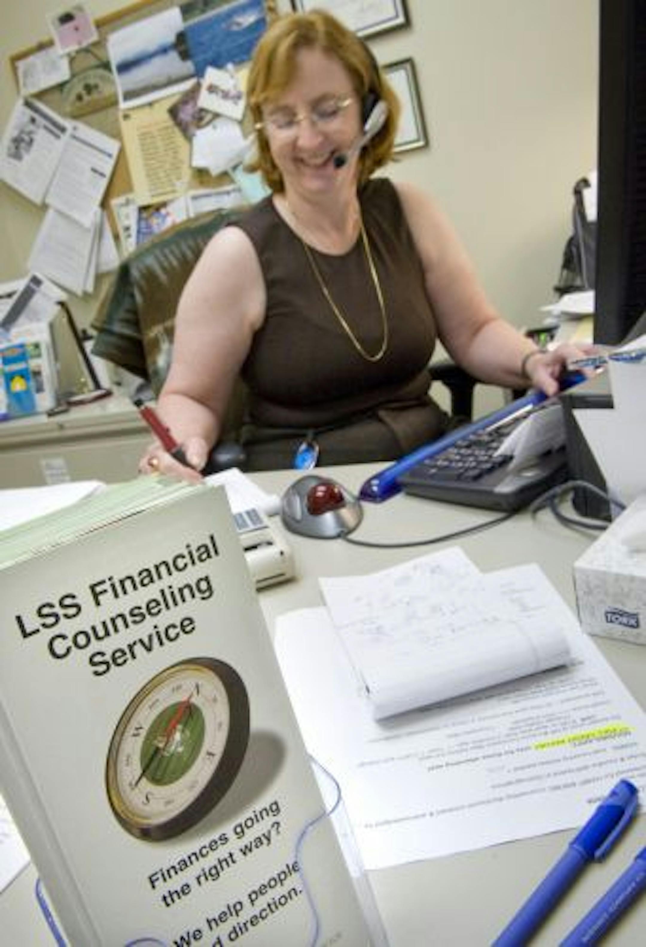 Lutheran Social Services financial counselor Pat Seger talked with a client about their financial situation Thursday afternoon.