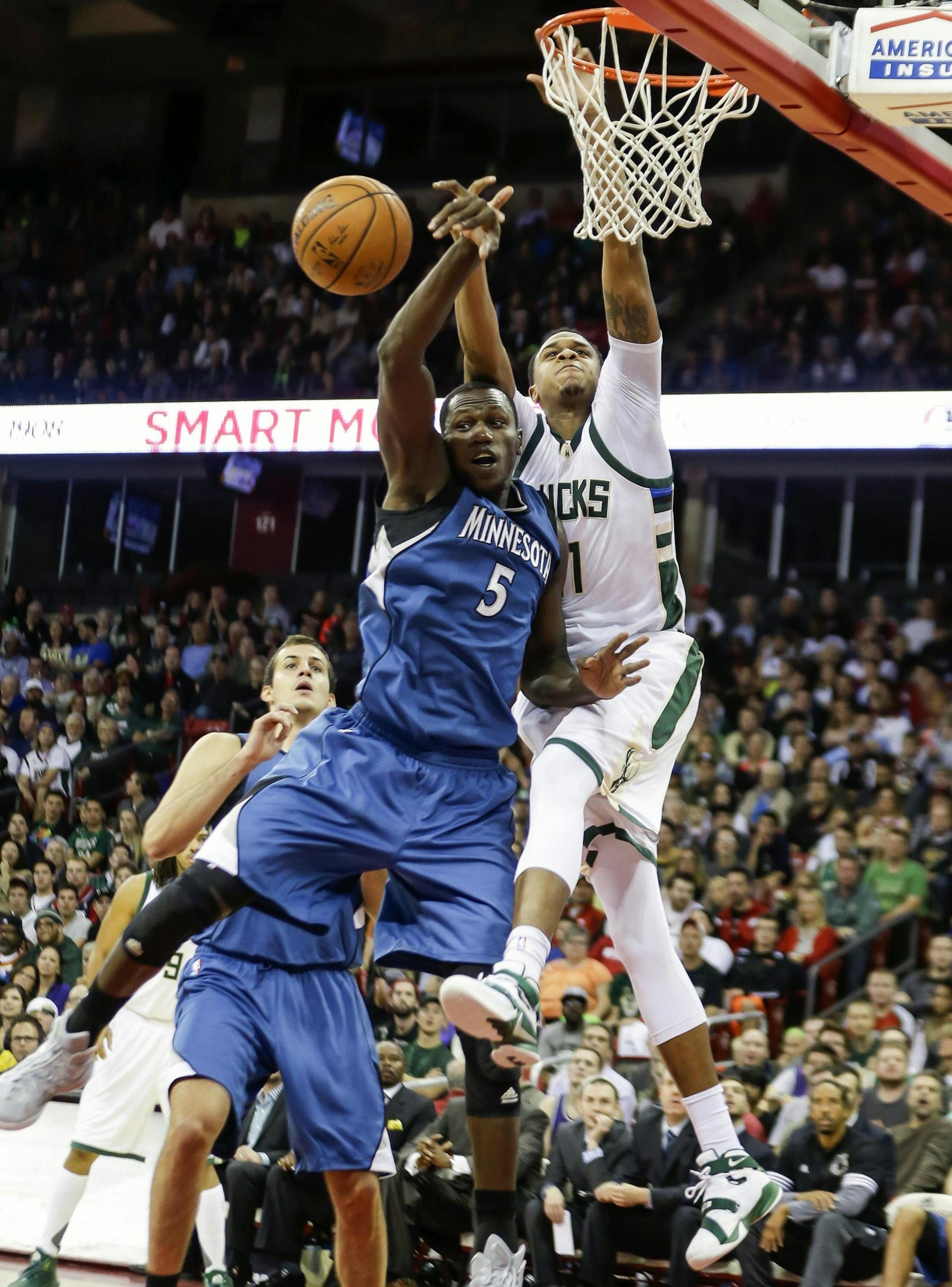 Minnesota Timberwolves' Gorgui Dieng (5) knocks a shoot away from Milwaukee Bucks' John Hanson during the first half of an NBA preseason basketball game Tuesday, Oct. 20, 2015, in Madison, Wis. (AP Photo/Andy Manis)