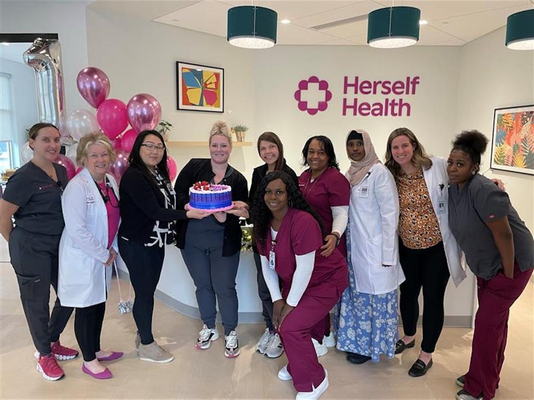 Herself Health staffers, including Dani Meuleners (fifth from left), director of clinical operations, celebrated the first patient at their clinic at 5450 Lyndale Ave. S. in Minneapolis.