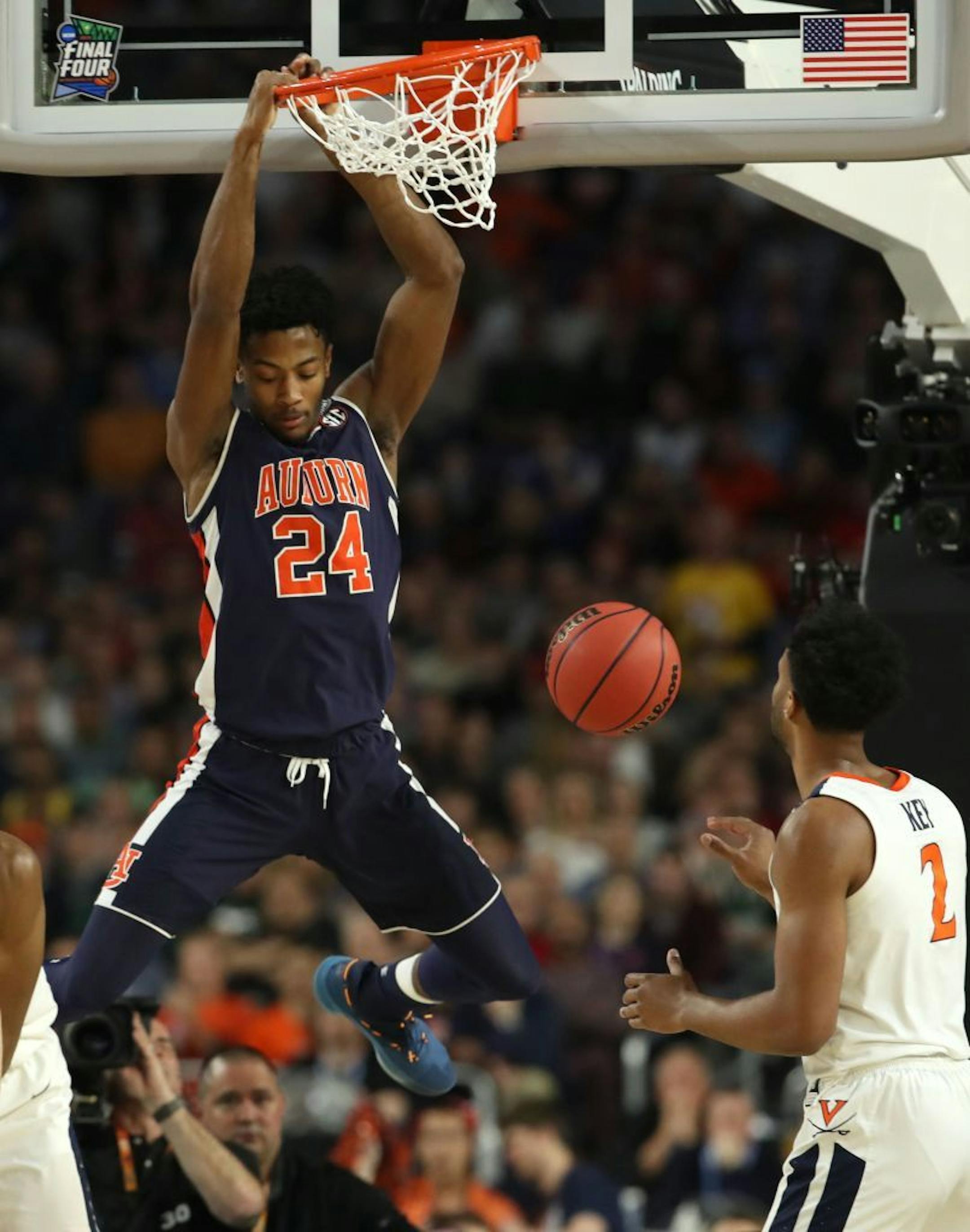 Auburn forward Anfernee McLemore (24) dunked against Virginia Cavaliers guard Braxton Key (2) during the first half.