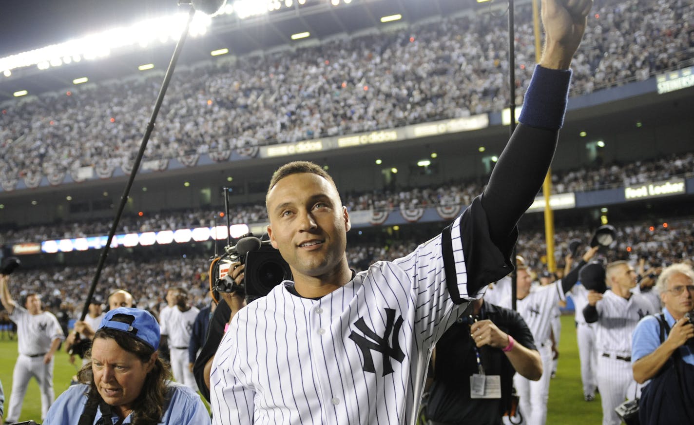 New York Yankees Derek Jeter waves to fans after the Yankees beat the Baltimore Orioles 7-3 in a baseball game at Yankee Stadium in New York on Sunday, Sept. 21, 2008. The baseball game was likely the last played at the stadium. (AP Photo/Ed Betz) ORG XMIT: NYY136