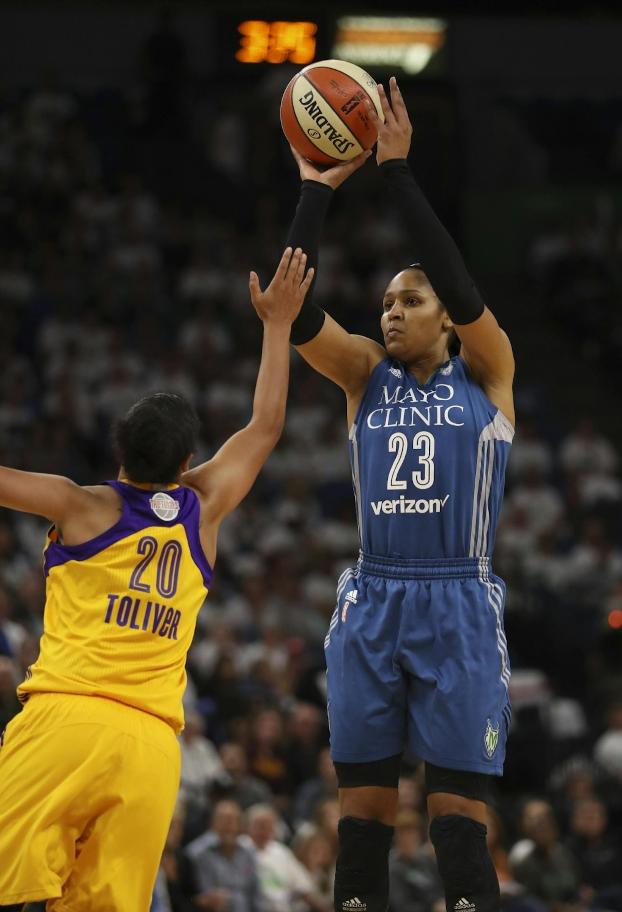 Minnesota Lynx forward Maya Moore (23) took a third quarter shot over Los Angeles Sparks guard Kristi Toliver (20).