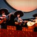 From left, Ivan Fontánez, Rodolfo Nieto and Israel Aranda, the three mariachi musicians, sing and strum during a dress rehearsal for the opera “Cru
