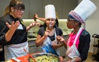 Twelve-year-old Tiffani Ford tasted the salad she prepared with teammate Jannan Ahmed and Foxy Falafel chef Erica Strait.