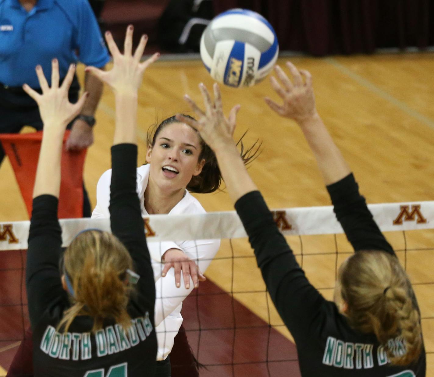 The University of Minnesota's Sarah Wilhite, white, kills a shot over North Dakota's Chelsea Moser (11) and Ahley Brueggeman (18) during the second set in the first round of the NCAA volleyball tournament at the Sports Pavilion on the University of Minnesota campus Friday, Dec. 2, 2016, in Minneapolis, MN.] (DAVID JOLES/STARTRIBUNE)djoles@startribune.com NCAA volleyball tournament coverage