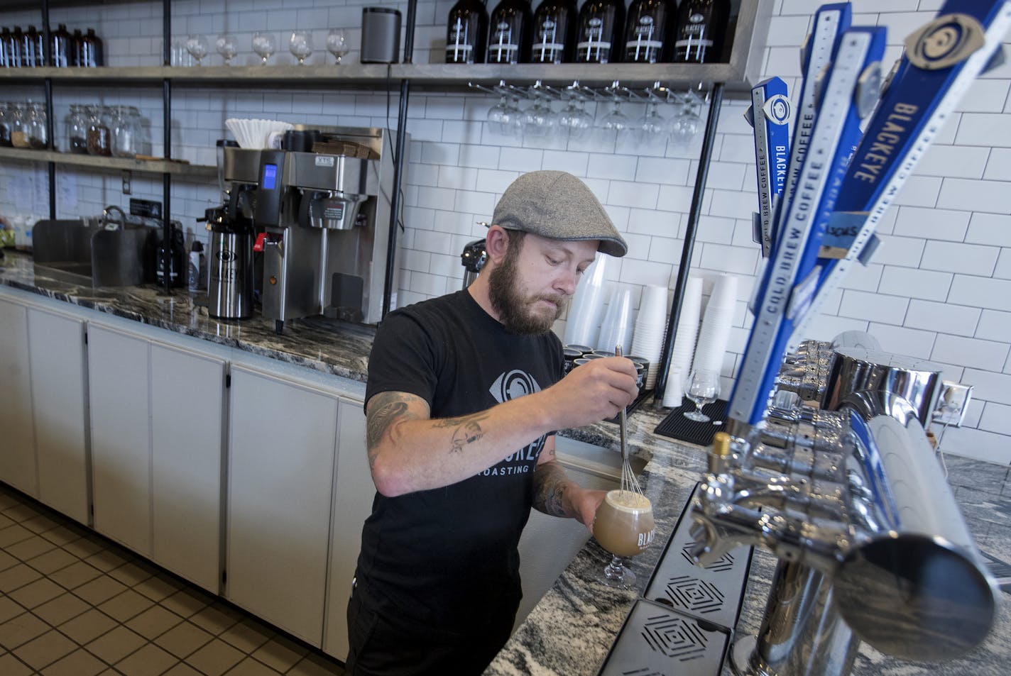 Adam Hart, general manager at Blackeye Roasting Co. in Minneapolis, prepared a nitro coffee dispensed from a tap, much like beer.