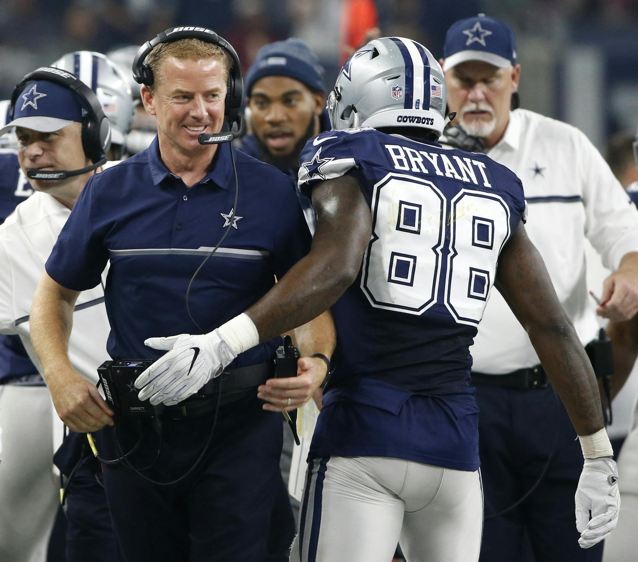 Dallas Cowboys head coach Jason Garrett smiles as he talks with Dez Bryant (88) during an NFL football game against the Washington Redskins on Thursday, Nov. 24, 2016, in Arlington, Texas. (AP Photo/Ron Jenkins)