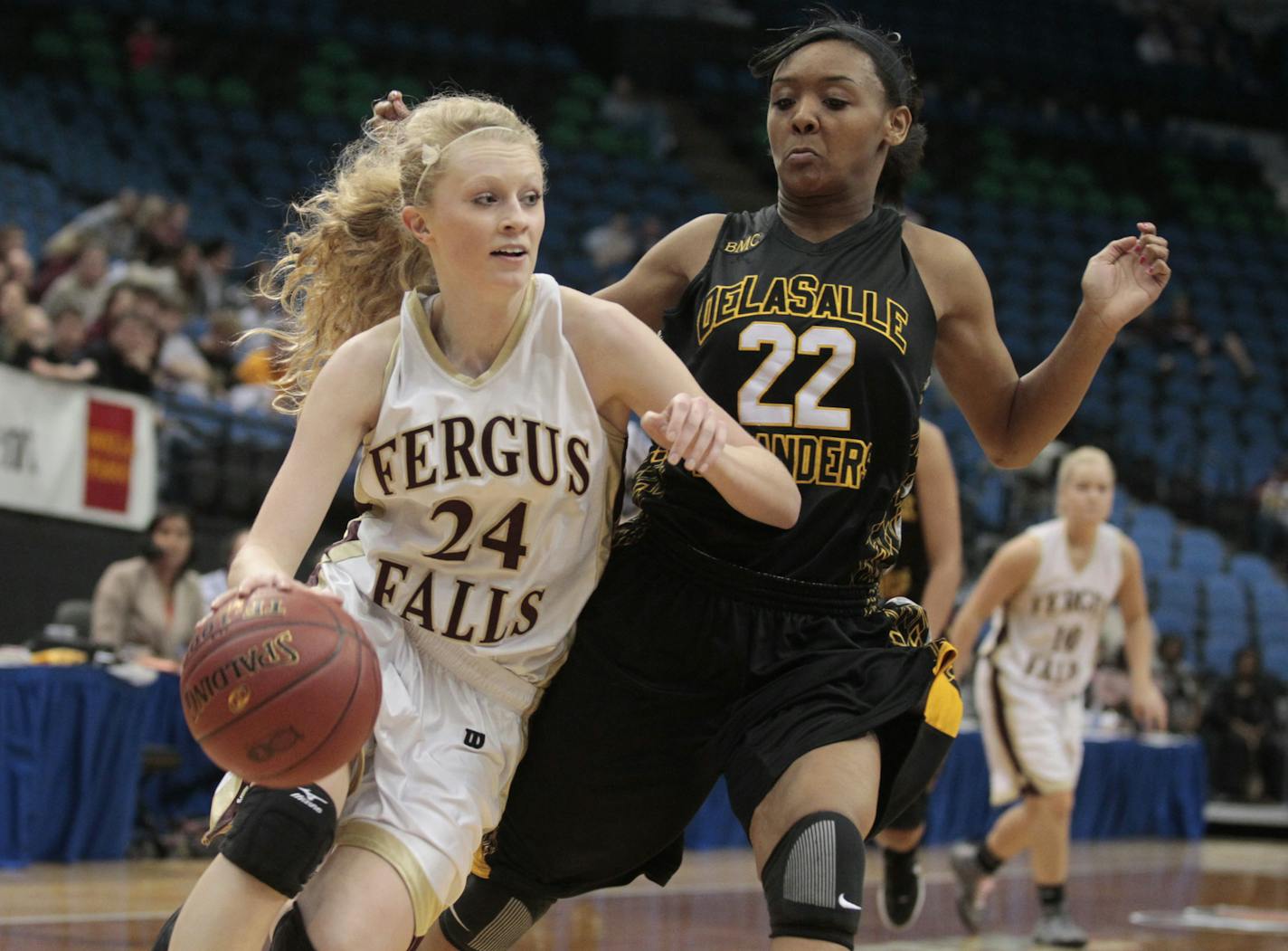Brianna Rasmusson of Fergus Falls drives to the basket over Tyseanna Johnson of DeLaSalle during Class 3A girls semifinals of the state girls tournament between DeLaSalle and Fergus Falls March 15, 2012 at Target Center in Minneapolis, MN.](Jerry Holt/ STAR TRIBUNE/jgholt@startribune.com)