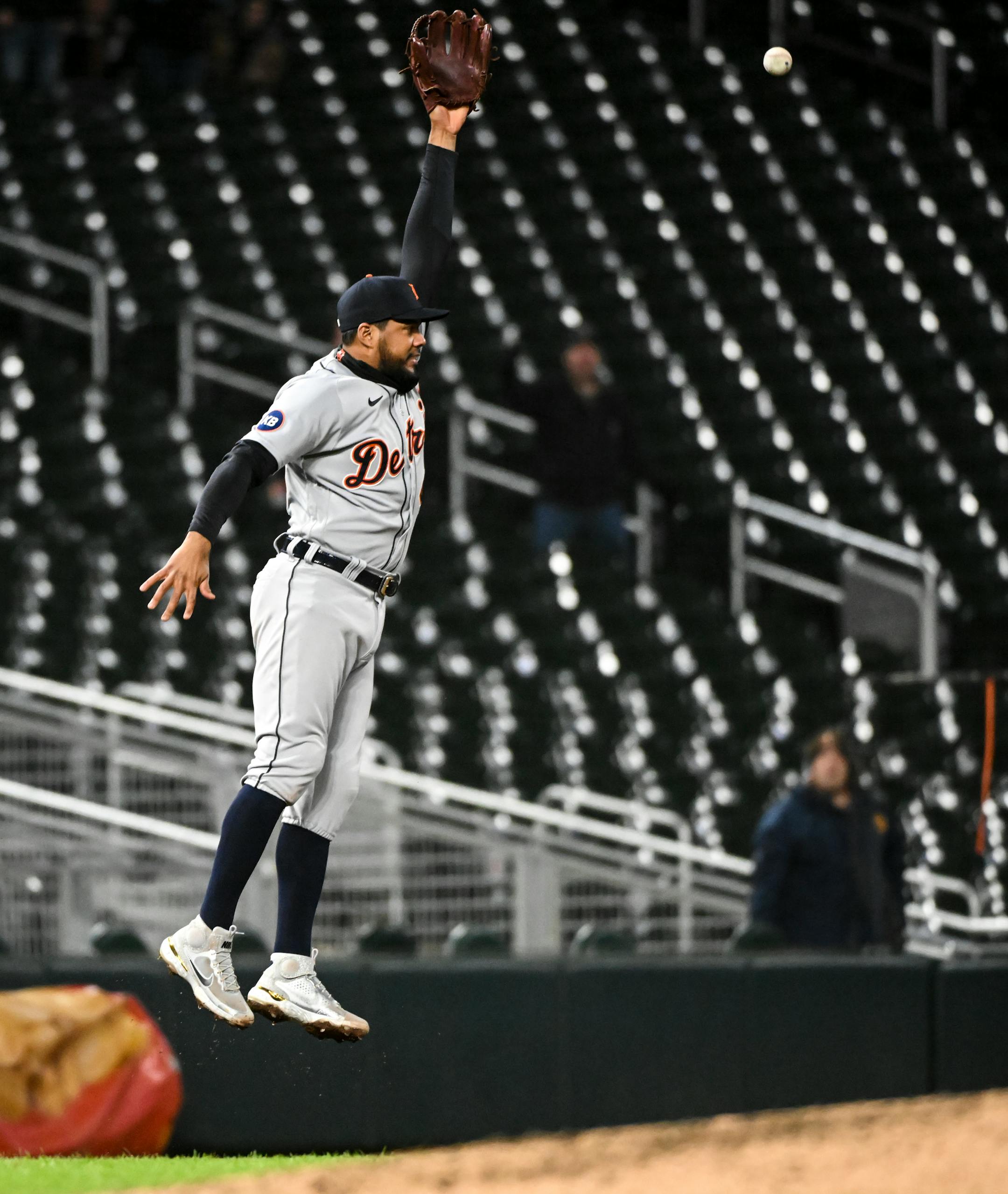 Detroit Tigers catcher hitter Eric Haase (13) overthrows the ball to third baseman Jeimer Candelario (46), leading to two Twins runs and the win in the bottom of the ninth inning.