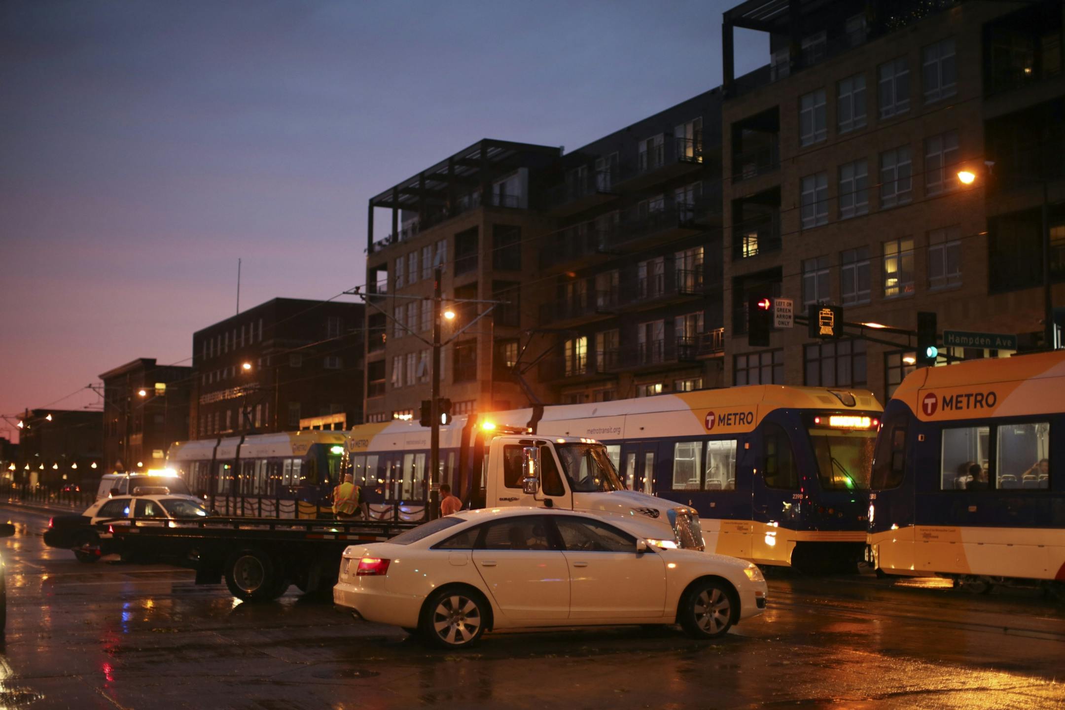 A Green Line train headed west past a vehicle just before it was removed from the intersection of W. University Ave. and N. Hampden Ave. in St. Paul.