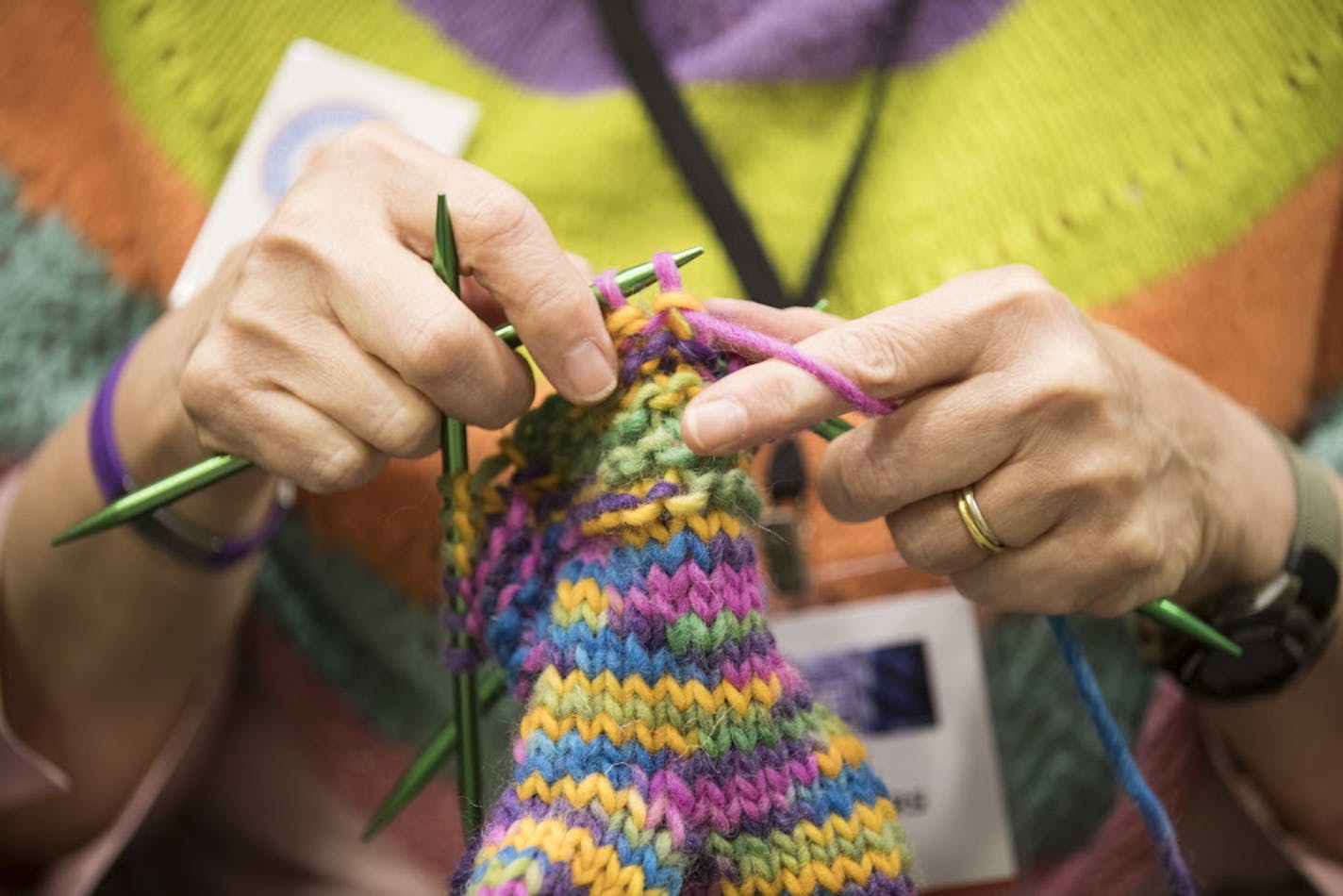 Kay Crowthers of the MN Knitter's Guild works on a pair of mittens during Vogue Knitting Live. ] (Leila Navidi/Star Tribune) leila.navidi@startribune.com BACKGROUND INFORMATION: The Vogue Knitting Live conference at the Minneapolis Convention Center on Sunday, November 6, 2016. The event features an opening yarn drop, boutique marketplace, workshops, a runway fashion show and yoga for knitters.