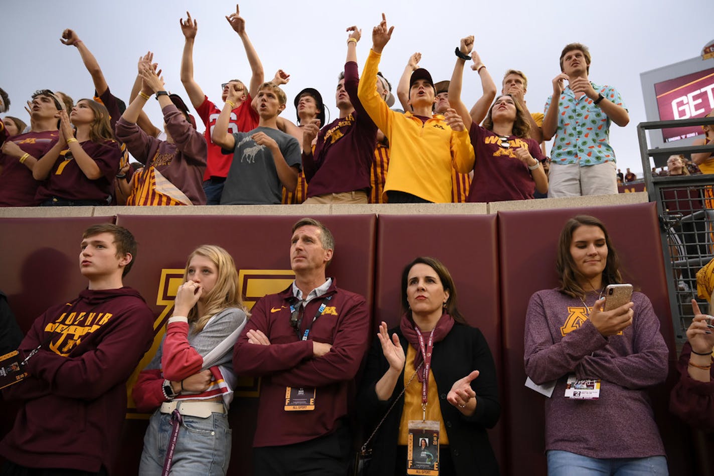 Athletic director Mark Coyle and University of Minnesota president Joan Gabel watched a football game last season surrounded by students at TCF Bank Stadium.