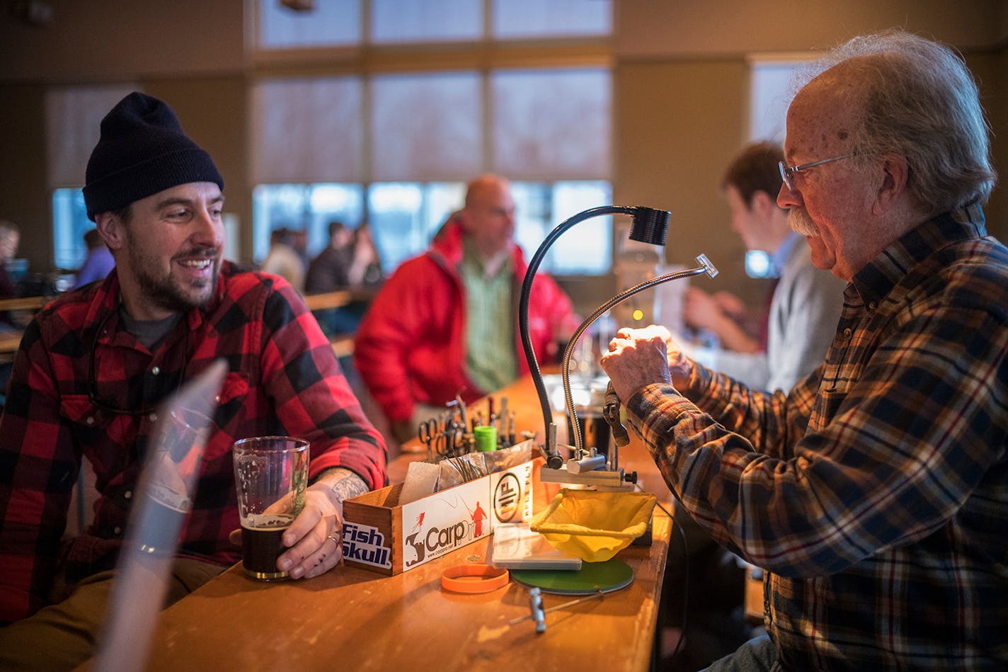 Aaron Przybylski and Bob Anderson enjoyed a pleasant chat over a beer at the St. Paul Fly Tiers' gathering at Summit Brewing Co. Anderson, 69, has been tying for around 60 years.