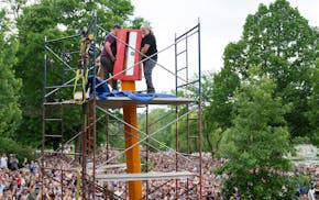 John Daugherty and Curtis Ingvoldstad, left to right, rotate the sharpener on the tip of the giant No. 2 pencil Saturday at the fourth annual Sharpeni