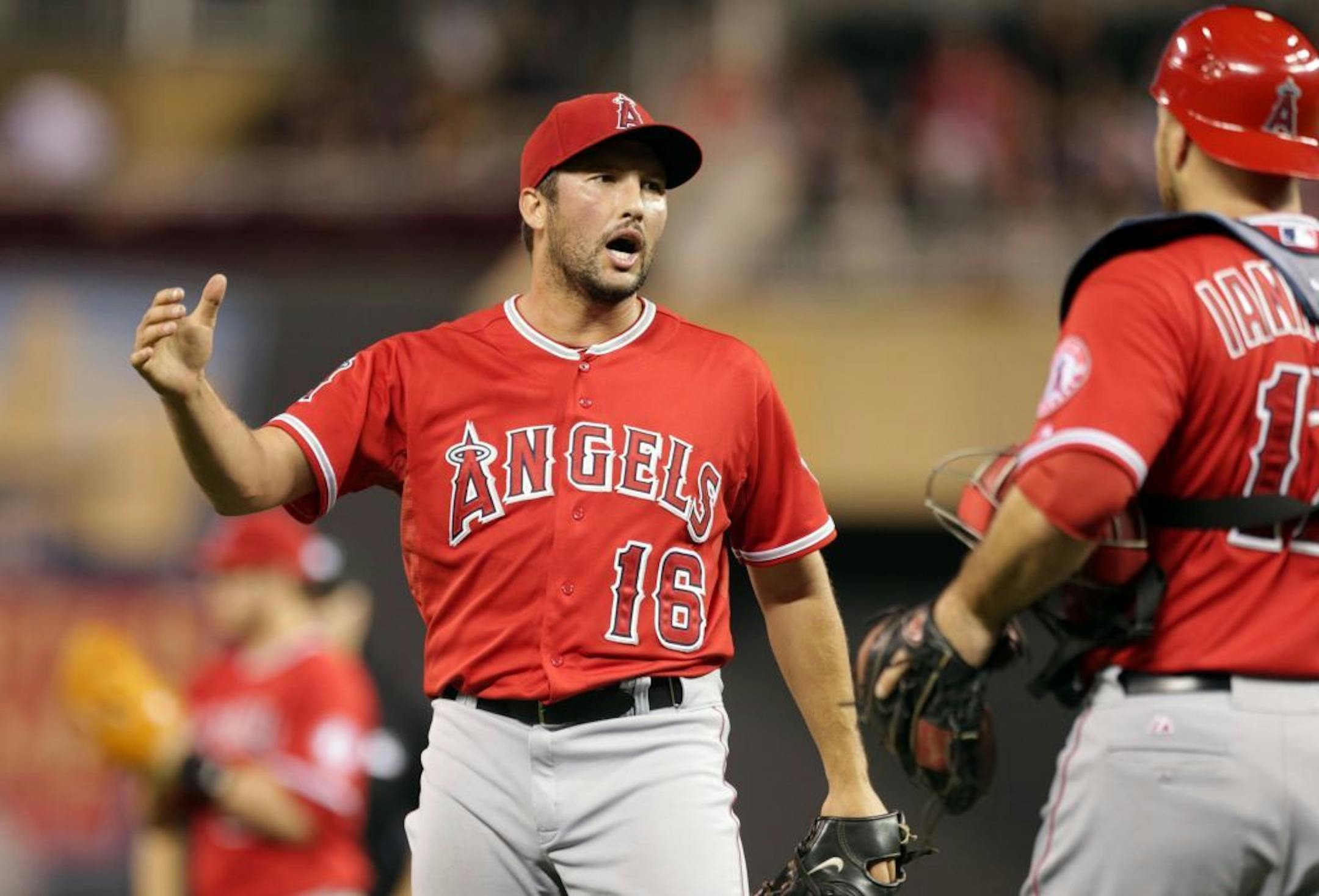 Los Angeles Angels pitcher Huston Street, left, and catcher Hank Conger celebrate after the Angels defeated the Minnesota Twins 5-4 in a baseball game, Thursday, Sept. 4, 2014, in Minneapolis.