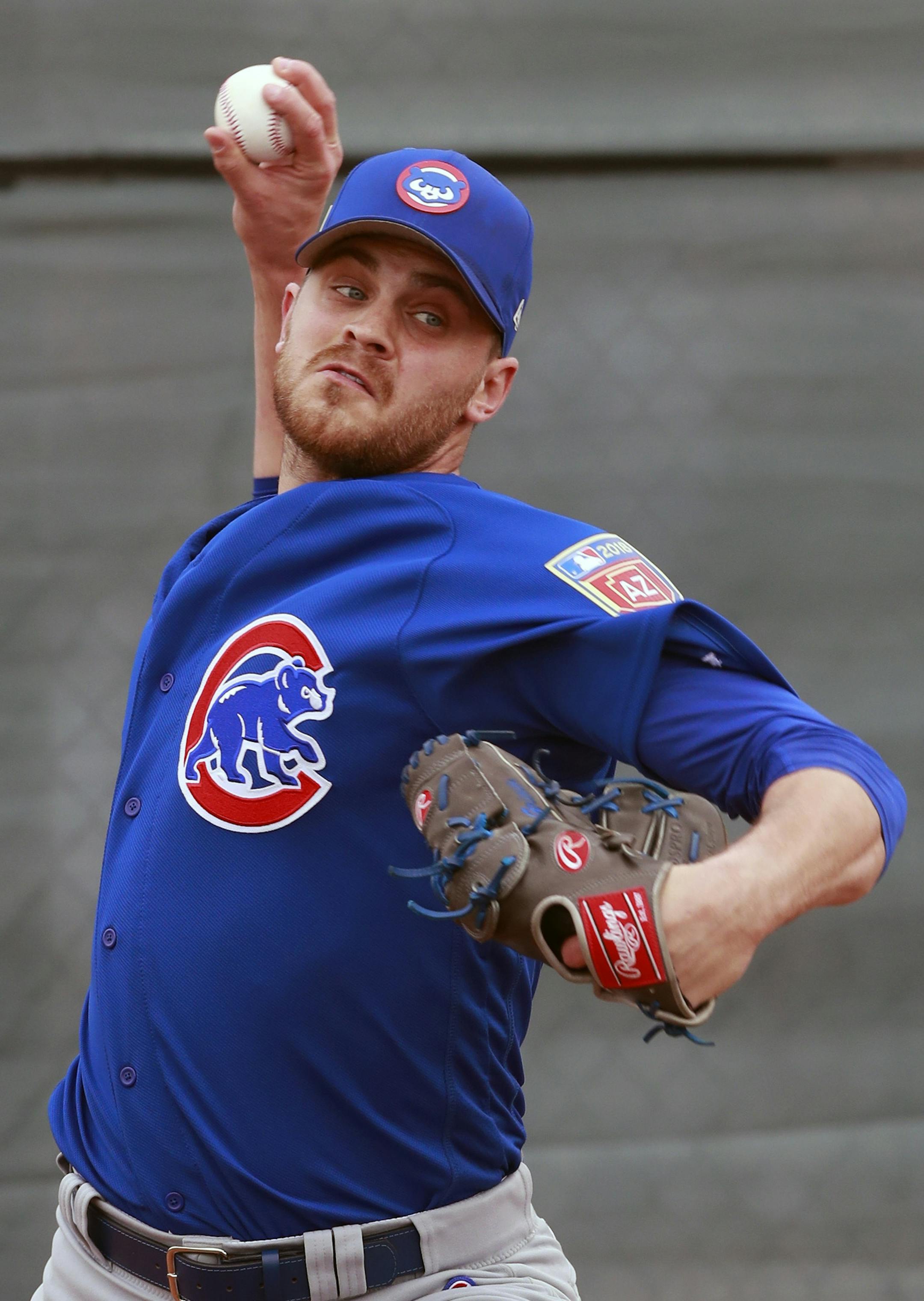 Chicago Cubs relief pitcher Justin Grimm throws during a drill at the team's spring training baseball facility Friday, Feb. 16, 2018, in Mesa, Ariz. (AP Photo/Carlos Osorio)