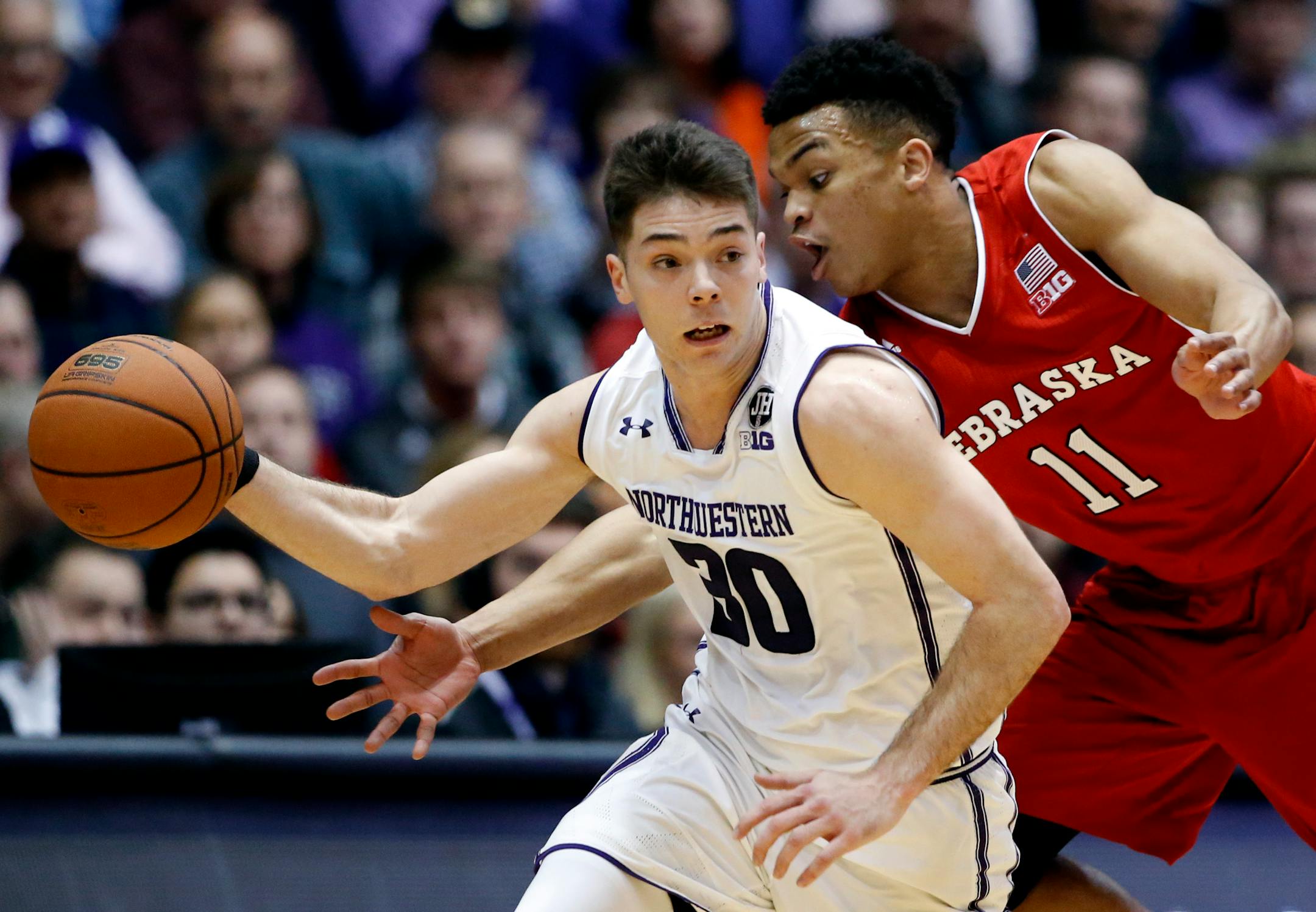 Northwestern guard Bryant McIntosh, left, looks to pass against Nebraska guard Evan Taylor during the second half of an NCAA college basketball game Thursday, Jan. 26, 2017, in Evanston, Ill. Northwestern won 73-61. (AP Photo/Nam Y. Huh) ORG XMIT: ILNH119