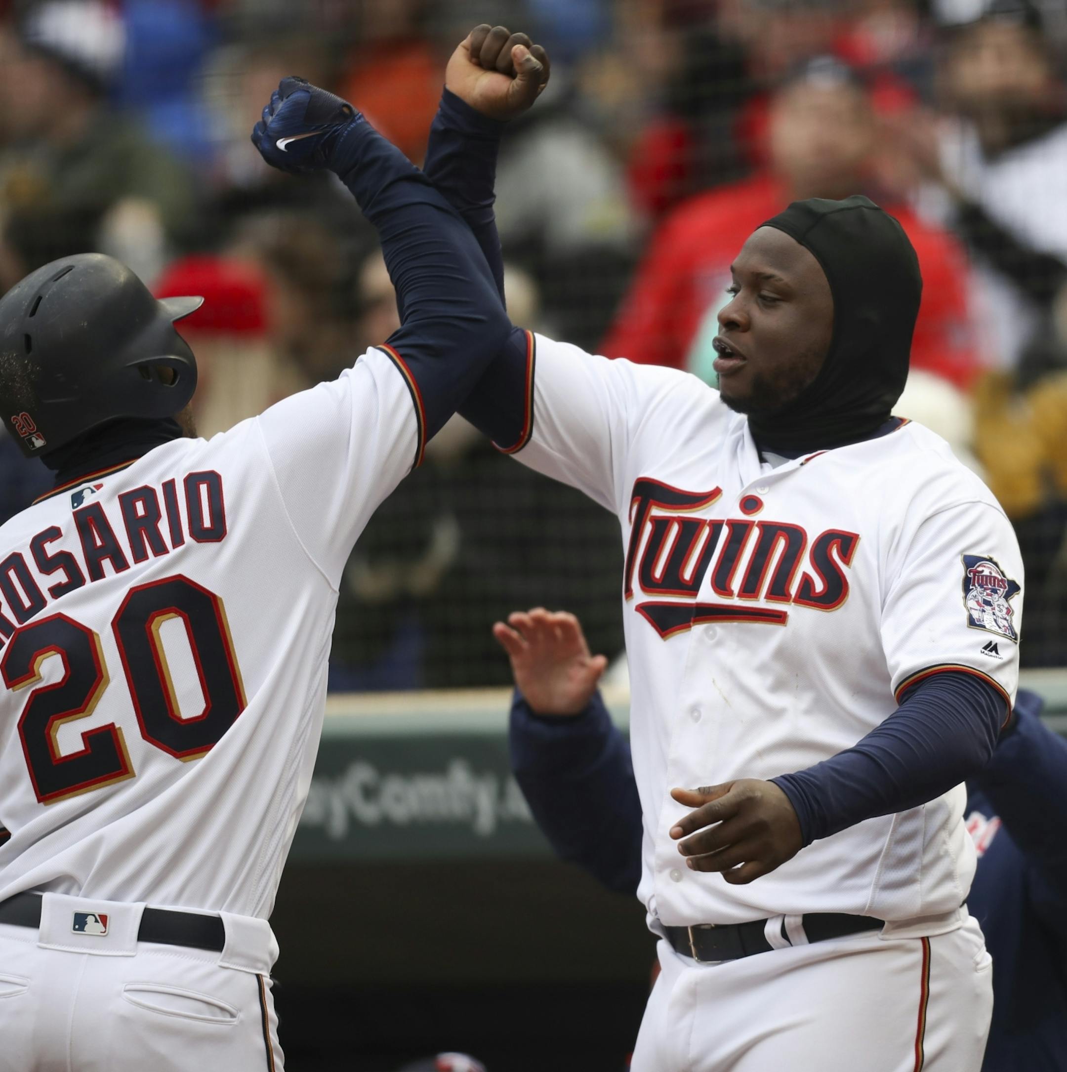 Minnesota Twins third baseman Miguel Sano (22) greeted Minnesota Twins left fielder Eddie Rosario (20) to celebrate his 8th inning home run that put the Twins ahead of Mariners 4-2.