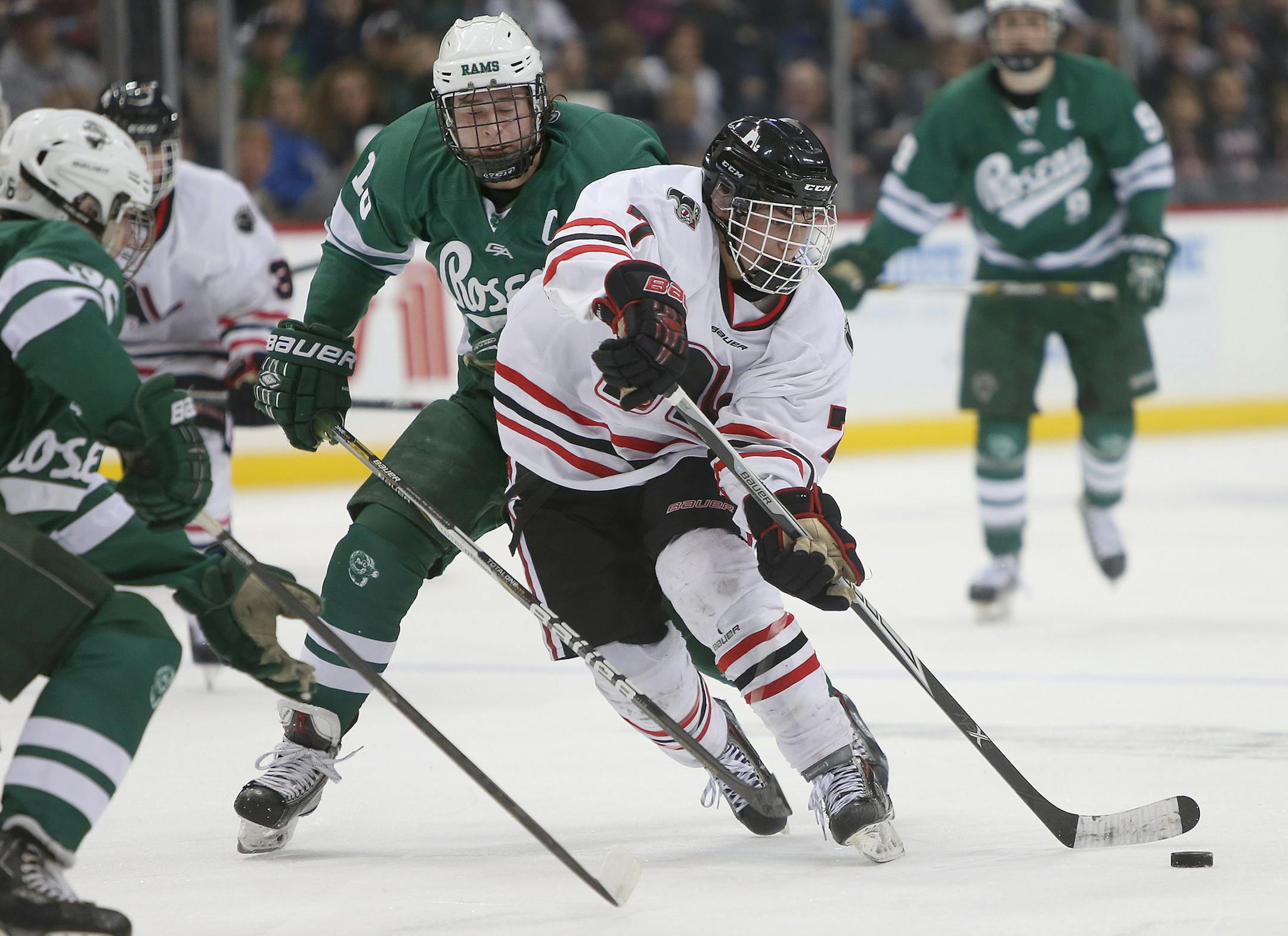 Lakeville North's Nick Poehling made it by Roseau's Zach Yon during the second period of the Class 2A boys' hockey state tournament at the Xcel Energy Center, Thursday, March 6, 2014. ] (ELIZABETH FLORES/STAR TRIBUNE) ELIZABETH FLORES • eflores@startribune.com