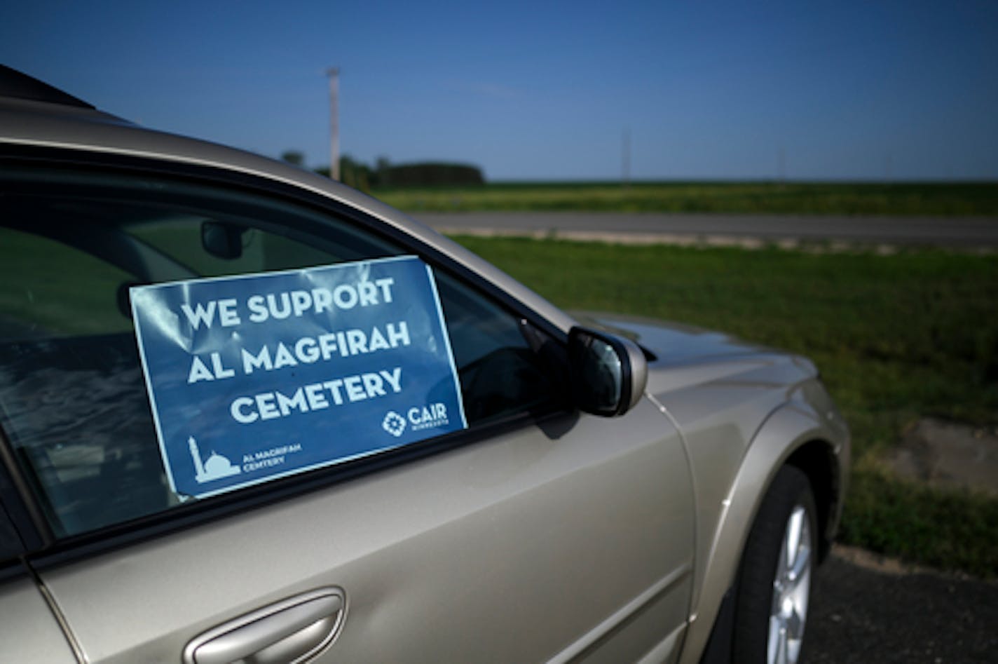 A poster in support of the Al Magfirah Cemetery is placed in a parked car Monday, June 20, 2022 outside Castle Rock Town Hall in Castle Rock Township, Minn.. The township held a public hearing Monday night regarding a conditional use permit for the Al Maghfirah Cemetery, a planned Muslim cemetery that has seen attempted arson and vandalism over the last several years. ] Aaron Lavinsky • aaron.lavinsky@startribune.com