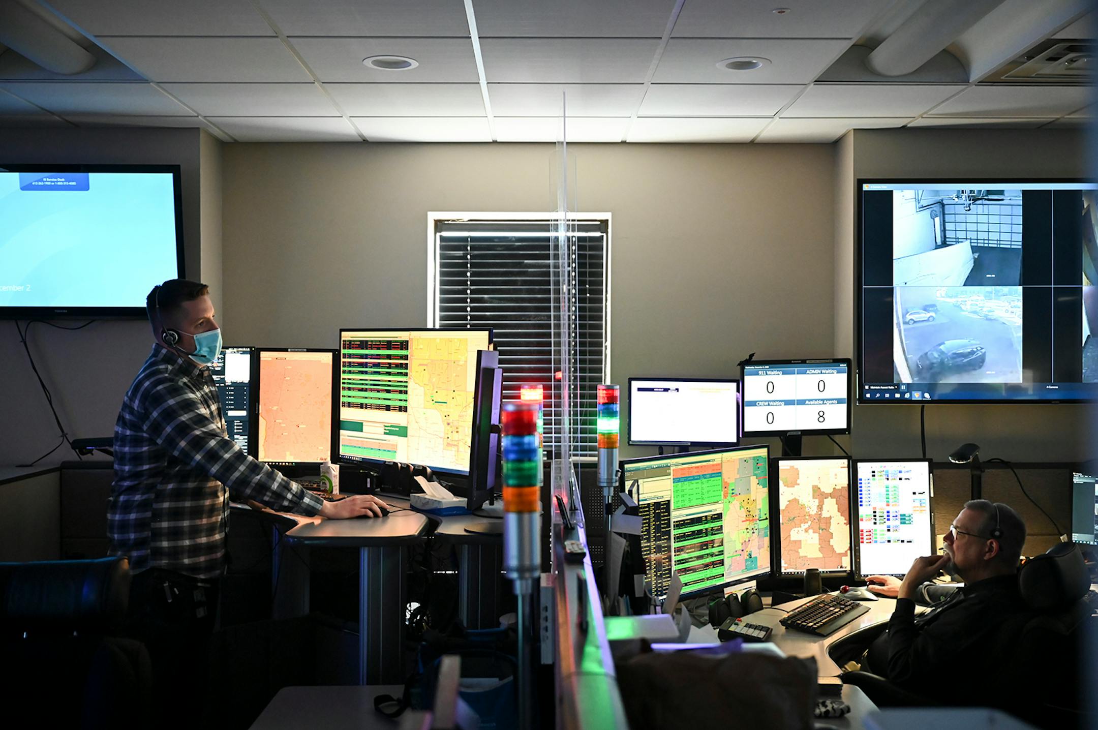 EMS dispatcher Dan Kiley, left, and Bryce Carlson, a dispatch duty supervisor with Allina, worked in Allina's Emergency Medical Services' St. Paul dispatch center Wednesday afternoon. ] AARON LAVINSKY • aaron.lavinsky@startribune.com Emergency medical workers and physician Andrew Stevens responded to possible COVID-19 related calls on Wednesday, Dec. 2, 2020 in the north Twin Cities metro.
