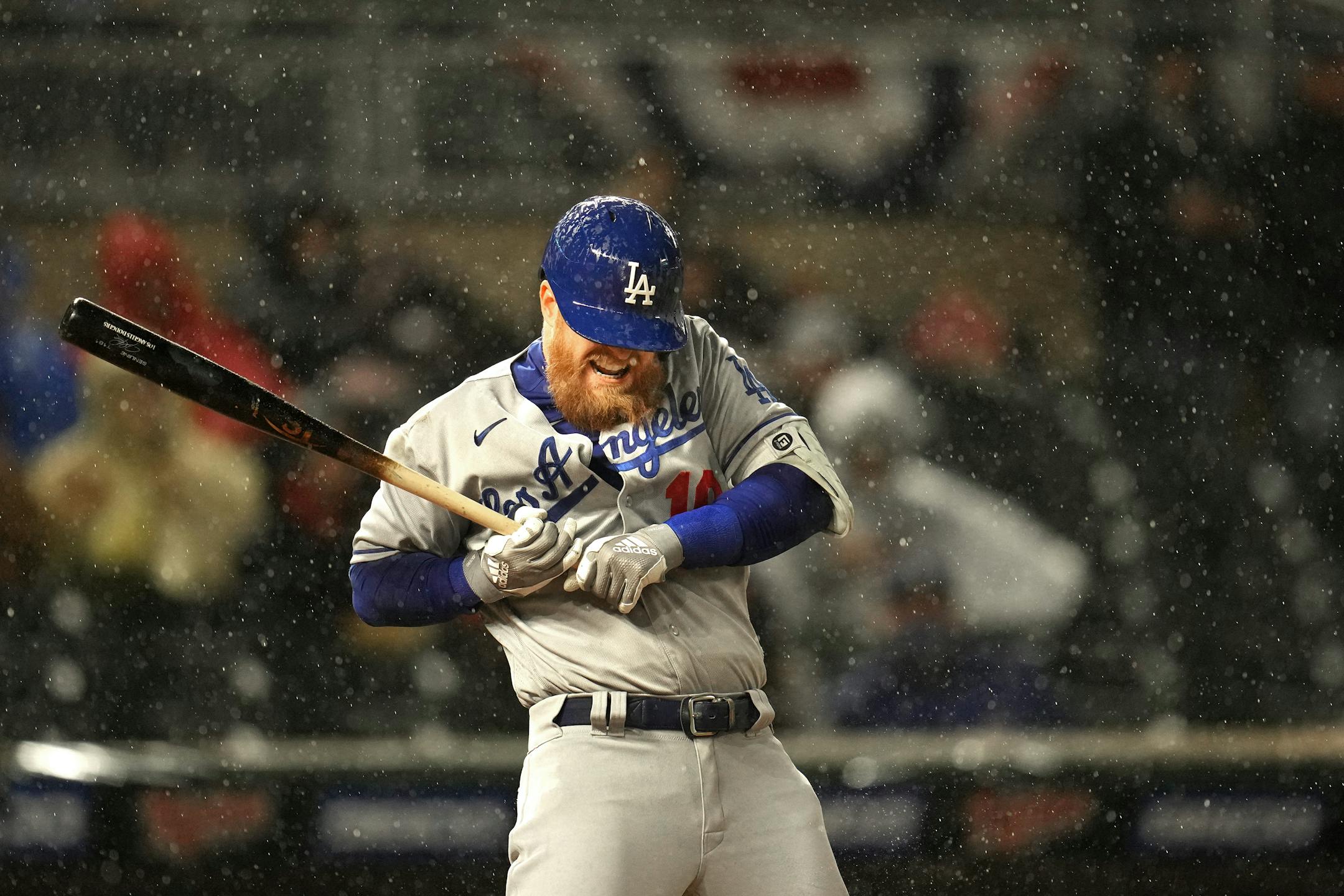 Los Angeles Dodgers third baseman Justin Turner (10) was almost hit by a pitch in the heavy rain.