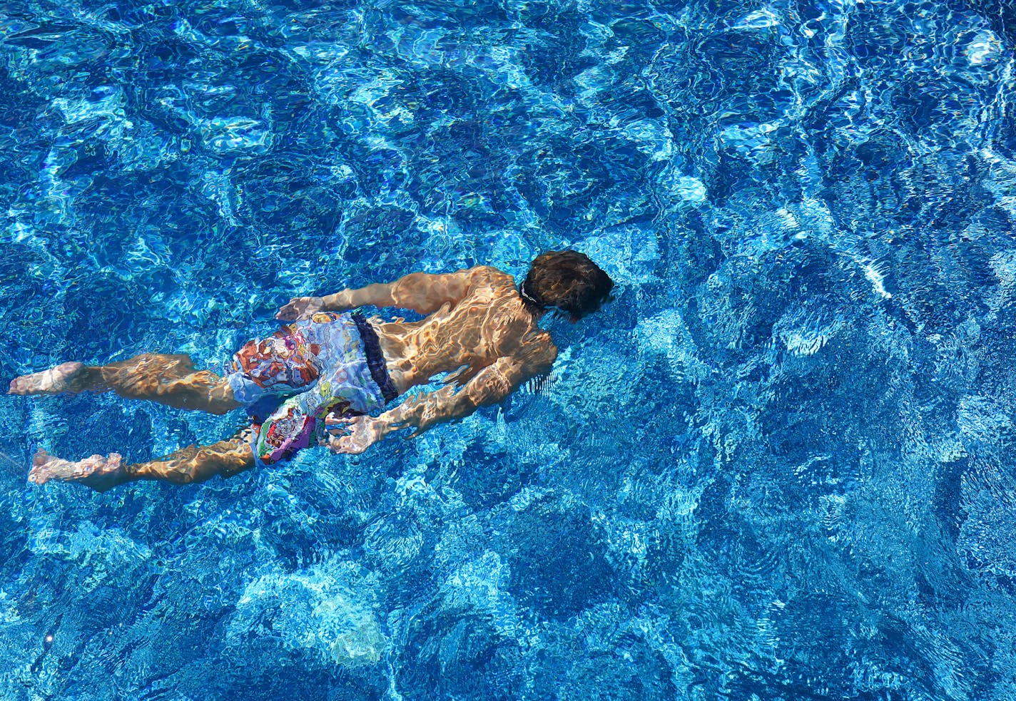 Jack Meyer, 9, swam underwater in his aunt and uncle's newly installed in-ground pool Tuesday. ] ANTHONY SOUFFLE • anthony.souffle@startribune.com The Lemcke family swam in their newly installed in-ground pool together Tuesday, Aug. 4, 2020 at their home in Ramsey, Minn.