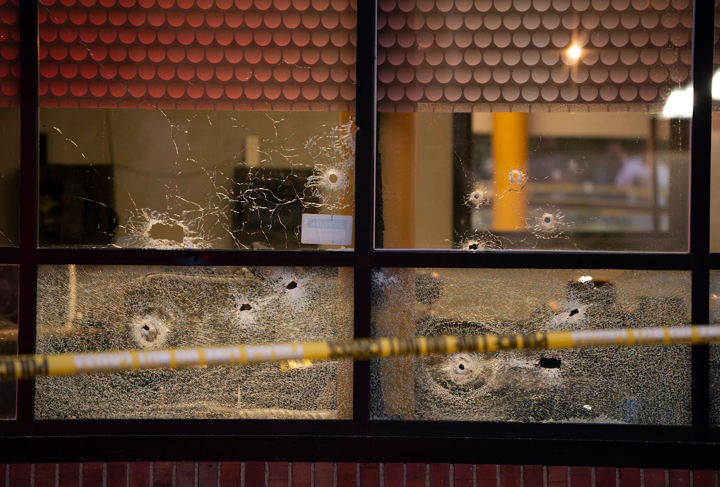 Bullet holes in the windows of the Clientele Barber Shop. ] JEFF WHEELER • jeff.wheeler@startribune.com