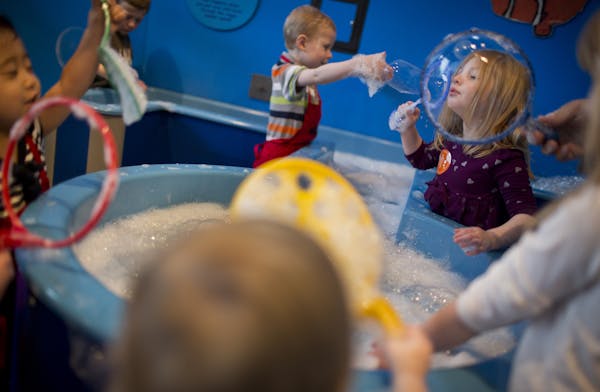 Emily Garden, at right, of Roberts, Wis., blew bubbles at the Children's Museum in St. Paul, Minn., on Friday, April 12, 2013. ] (RENEE JONES SCHNEIDE