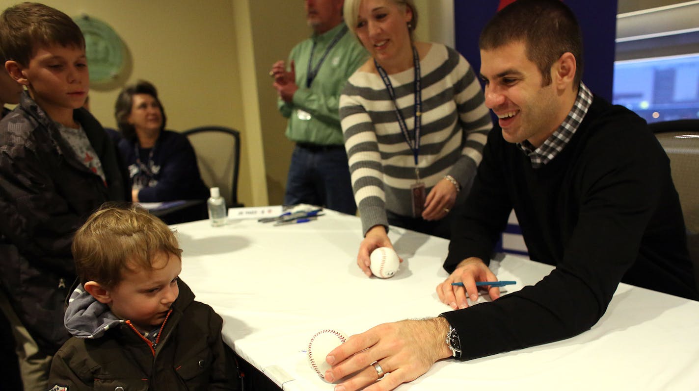 Twin Joe Mauer tried to hand a signed ball back to a shy Preston Snyder, 3, during the first day of TwinFest at Target Field in Minneapolis Friday, January 22, 2013. ] (KYNDELL HARKNESS/STAR TRIBUNE) kyndell.harkness@startribune.com