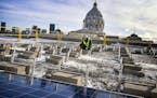 Crews began installing rooftop solar panels on the Minnesota Senate Building at the Capitol complex.
