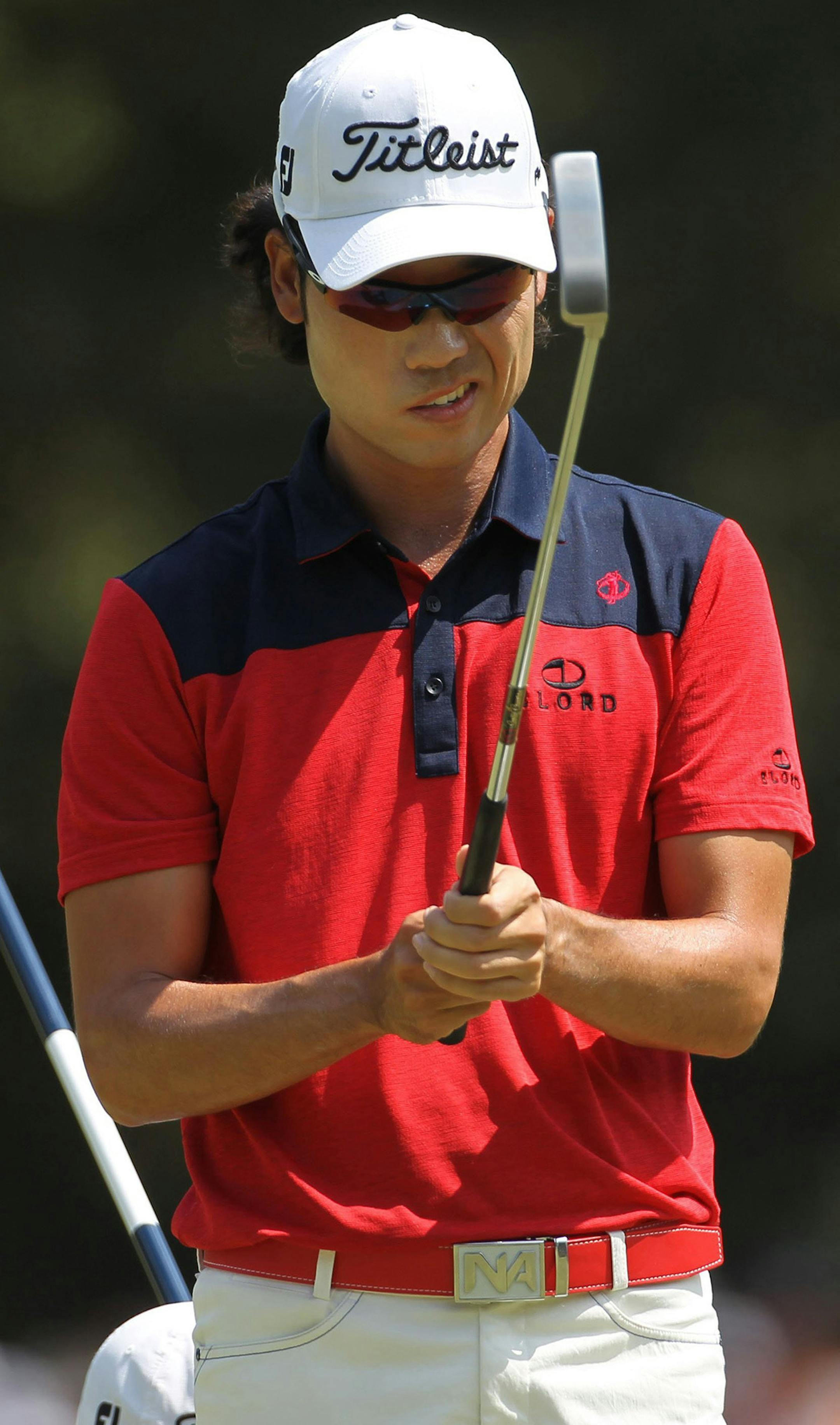 Golfer Kevin Na of Seoul, South Korea, lines up his putt on the first hole during the third round of the 2014 U.S. Open at Pinehurst No. 2 in Pinehurst, N.C., Saturday, June 14, 2014.
