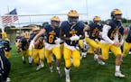 Rosemount High receiver Jonathan Mann (1), who is also a Gopher recruit, heads onto the field with teammates to take on Lakeville North Friday, Sept. 