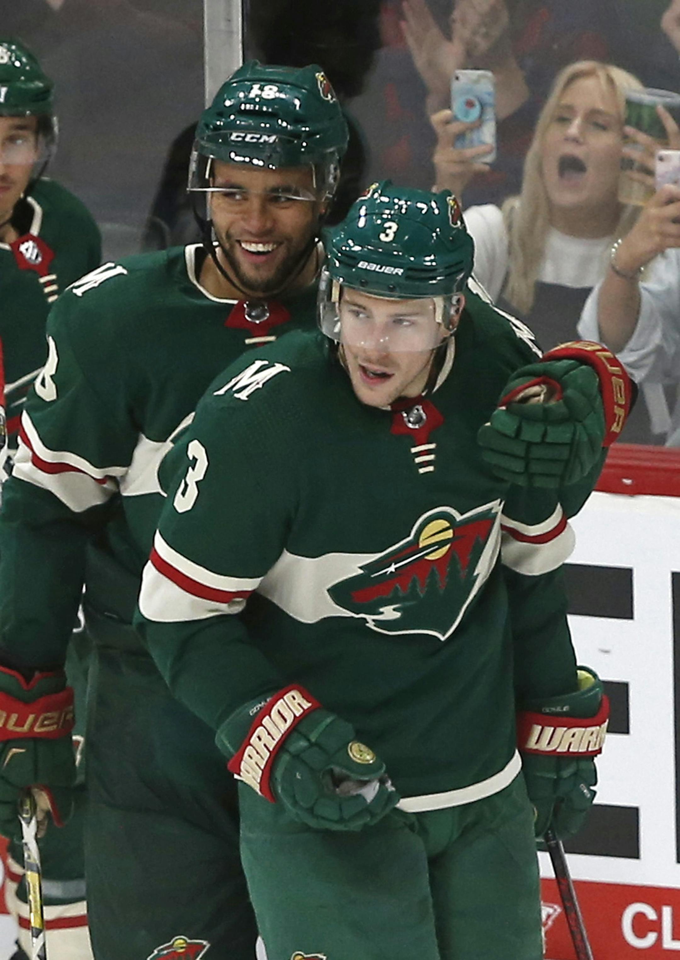 Minnesota Wild's Jordan Greenway, left, congratulates Charlie Coyle after Coyle scored his third goal for the hat trick in the third period off Colorado Avalanche's goalie Philipp Grubauer, Saturday, Sept. 22, 2018, in St. Paul, Minn. (AP Photo/Jim Mone)