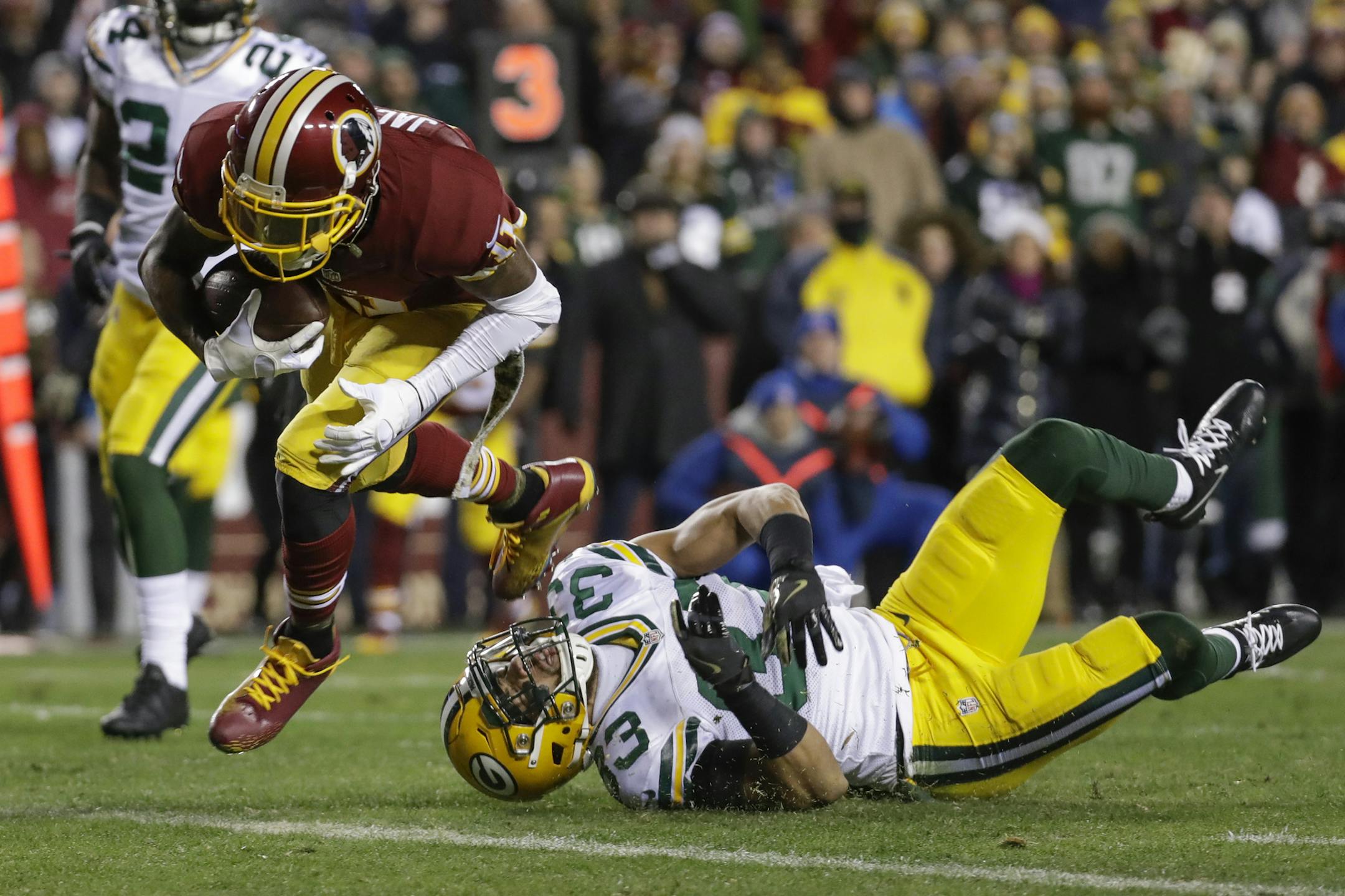 Washington Redskins wide receiver DeSean Jackson (11) scores a touchdown after breaking a tackle by Green Bay Packers strong safety Micah Hyde (33) during the first half of an NFL football game in Landover, Md., Sunday, Nov. 20, 2016. (AP Photo/Patrick Semansky)