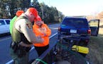 DNR conservation officer Brent Grewe checked the license of Bridget Benhardus of Rice, Minn., who bagged a five-point buck.