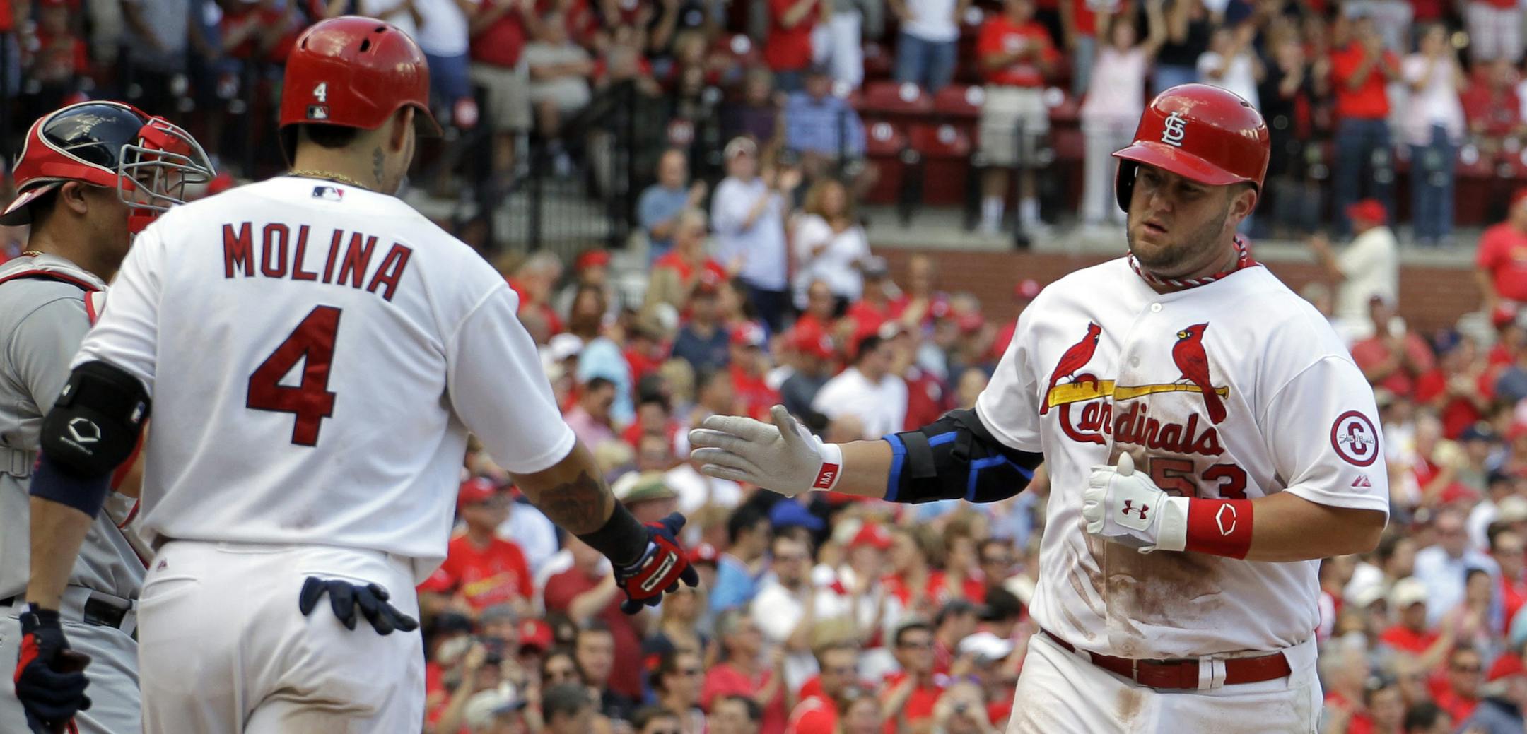 St. Louis Cardinals' Matt Adams, right, is congratulated by Yadier Molina after hitting a solo home run during the sixth inning of a baseball game against the Washington Nationals Wednesday, Sept. 25, 2013, in St. Louis. (AP Photo/Jeff Roberson) ORG XMIT: MOJR115