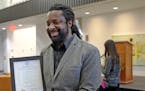 Marlon James poses with Gov. Mark Dayton's proclamation of Marlon James Day, Oct. 28, 2015, in Minnesota. James, a professor at Macalester College, is