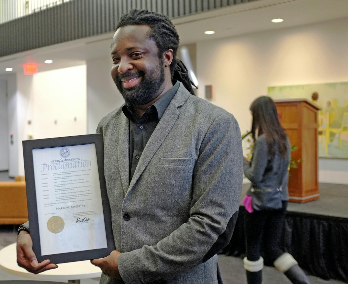 Marlon James poses with Gov. Mark Dayton's proclamation of Marlon James Day, Oct. 28, 2015, in Minnesota. James, a professor at Macalester College, is the author of "A Brief History of Seven Killings," which won the Man Booker Prize, one of the literary world's most esteemed awards.