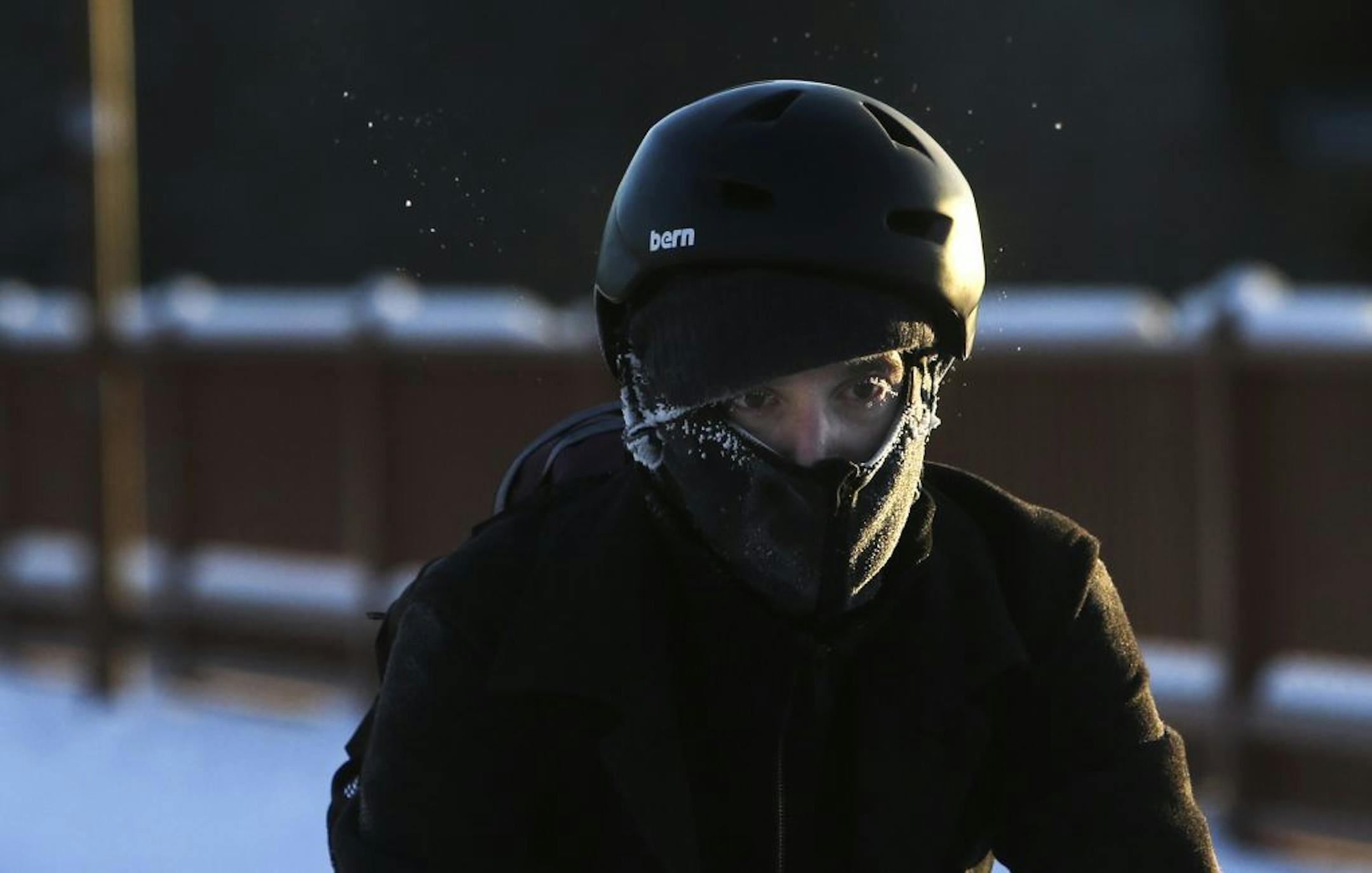 A semi-frosted bicylist makes his way across the Stone Arch Bridge amid dangerously cold temperatures Dec. 11, 2013 in Minneapolis.
