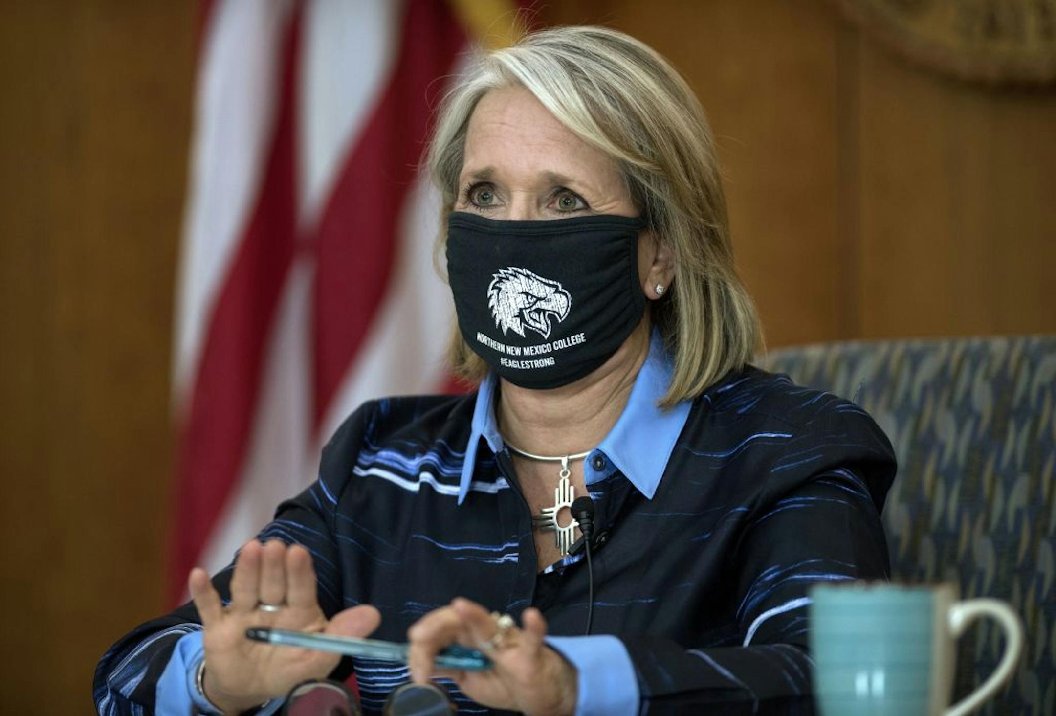 In this Thursday, July 23, 2020, photo, Gov. Michelle Lujan Grisham gives her weekly update on COVID-19 and the state's effort to contain it during a virtual news conference from the state Capitol in Santa Fe, N.M. Grisham was an early adopter of aggressive pandemic restrictions that included a mask mandate, self-quarantine orders for travelers and a ban on public gatherings -- now capped at five people. And the state previously joined federal pilot project on testing and contact tracing.