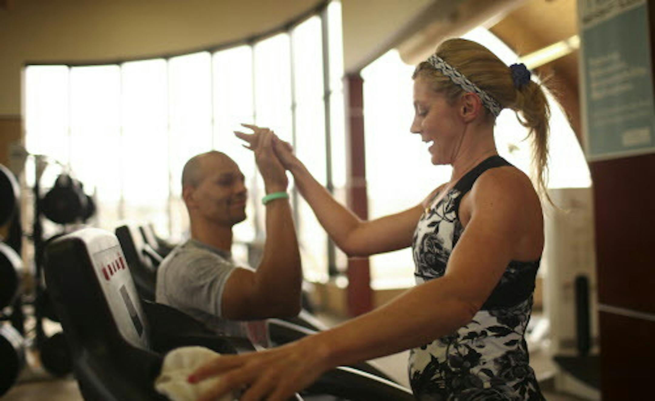 Life Time Fitness events coordinator Julie Oyen high fived her personal trainer, Mike Knox, after finishing the treadmill portion of her workout Monday afternoon at the facility in Eden Prairie. ] JEFF WHEELER ï jeff.wheeler@startribune.com Chanhassen-based Life Time Fitness Inc. announced Monday, March 16, 2015 that it has agreed to be sold for more than $4 billion to private-equity investors. Monday afternoon, users were working out at the company's showcase fitness club in Eden Prairie.