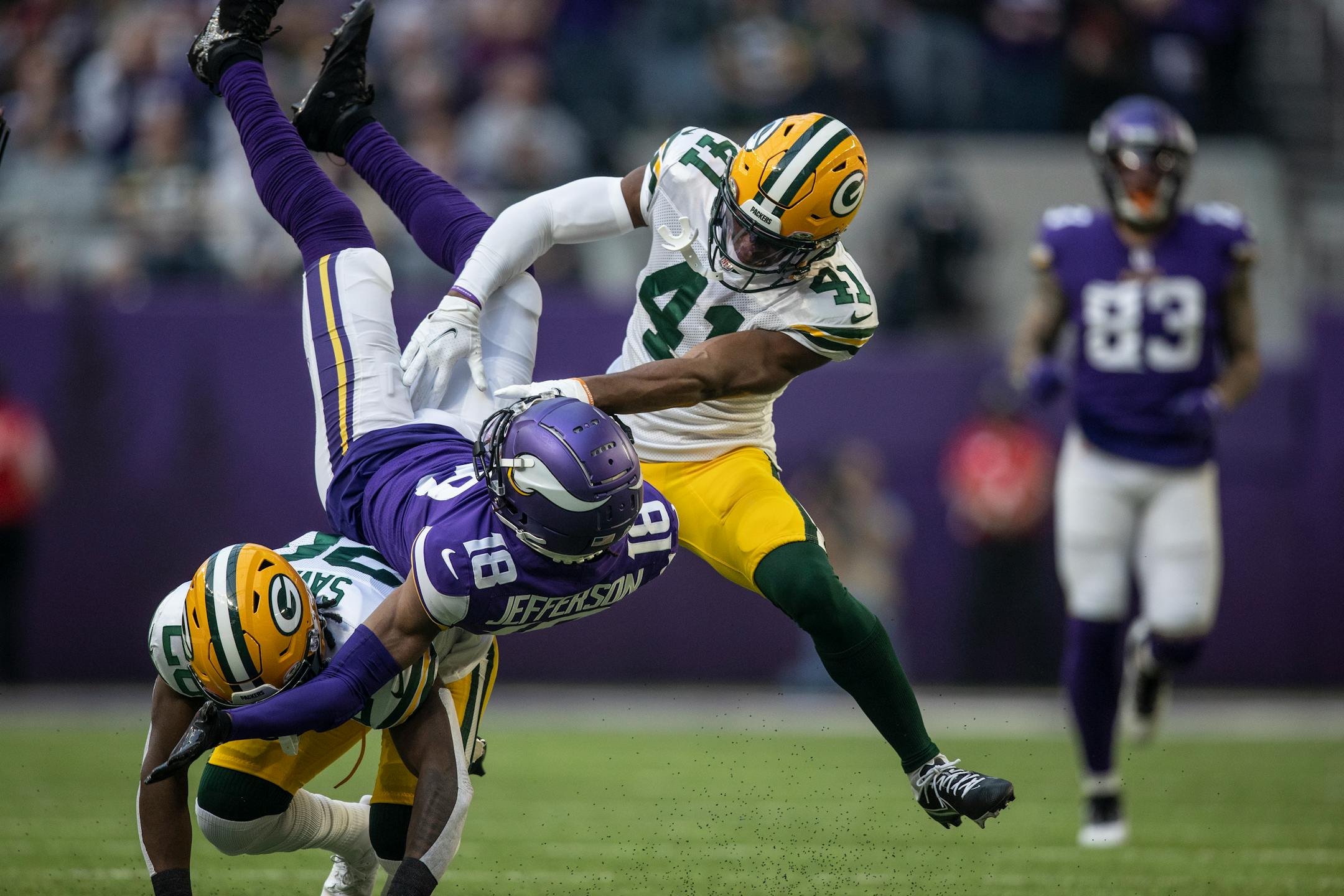 Green Bay Packers free safety Darnell Savage (26) and  safety Henry Black (41) tackled Minnesota Vikings wide receiver Justin Jefferson (18) after he picked up a first down in the first quarter.