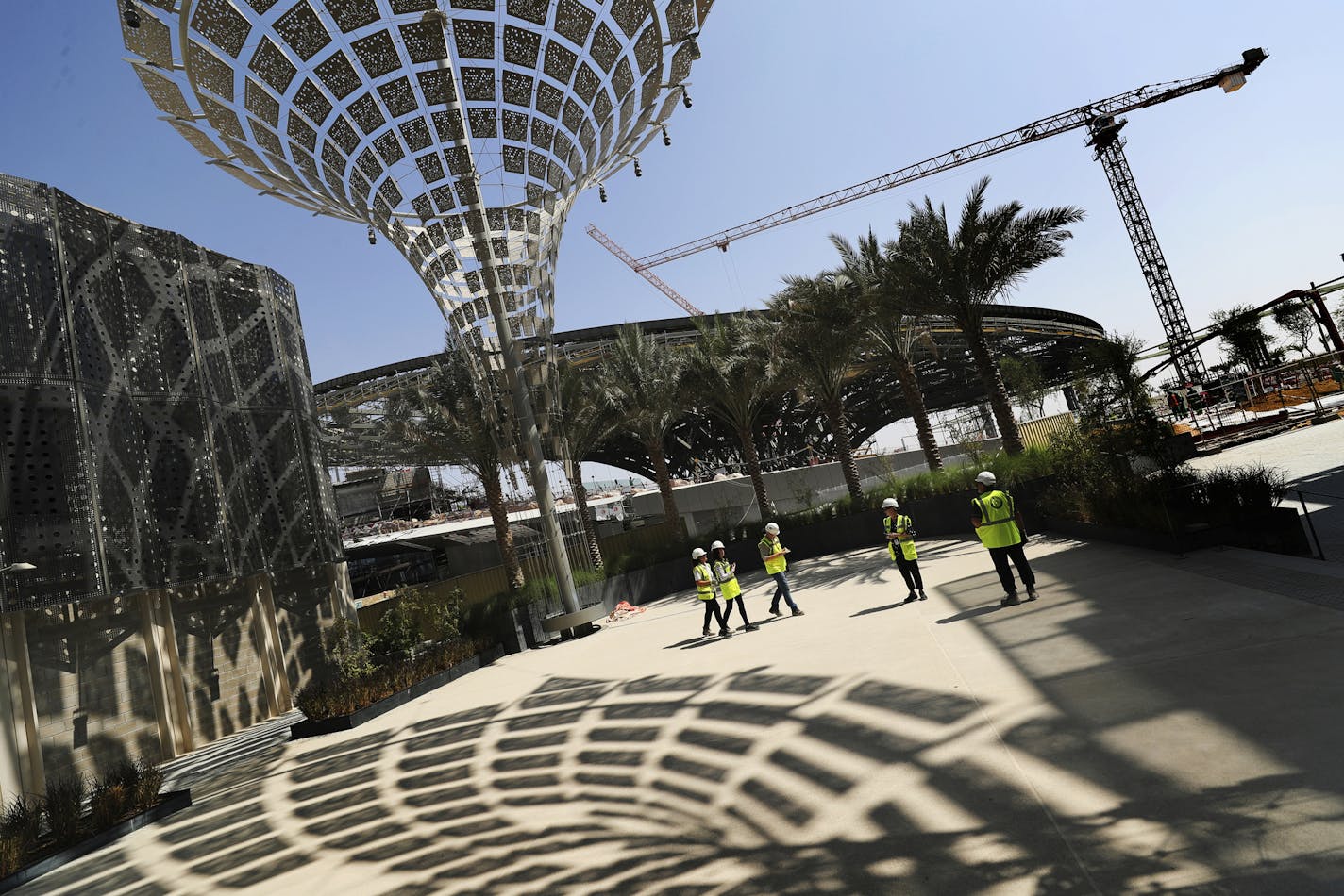 In this Oct. 8, 2019, photo, Associated Press journalists visit the Sustainability Pavilion at the under construction site of the Expo 2020 in Dubai, United Arab Emirates. Its Sustainability Pavilion, which recalls the towers of New York&#x2019;s 1964 world&#x2019;s fair, will be covered in solar panels and surrounded by similarly paneled &#x201c;energy trees&#x201d; to make it a zero-energy structure. (AP Photo/Kamran Jebreili)