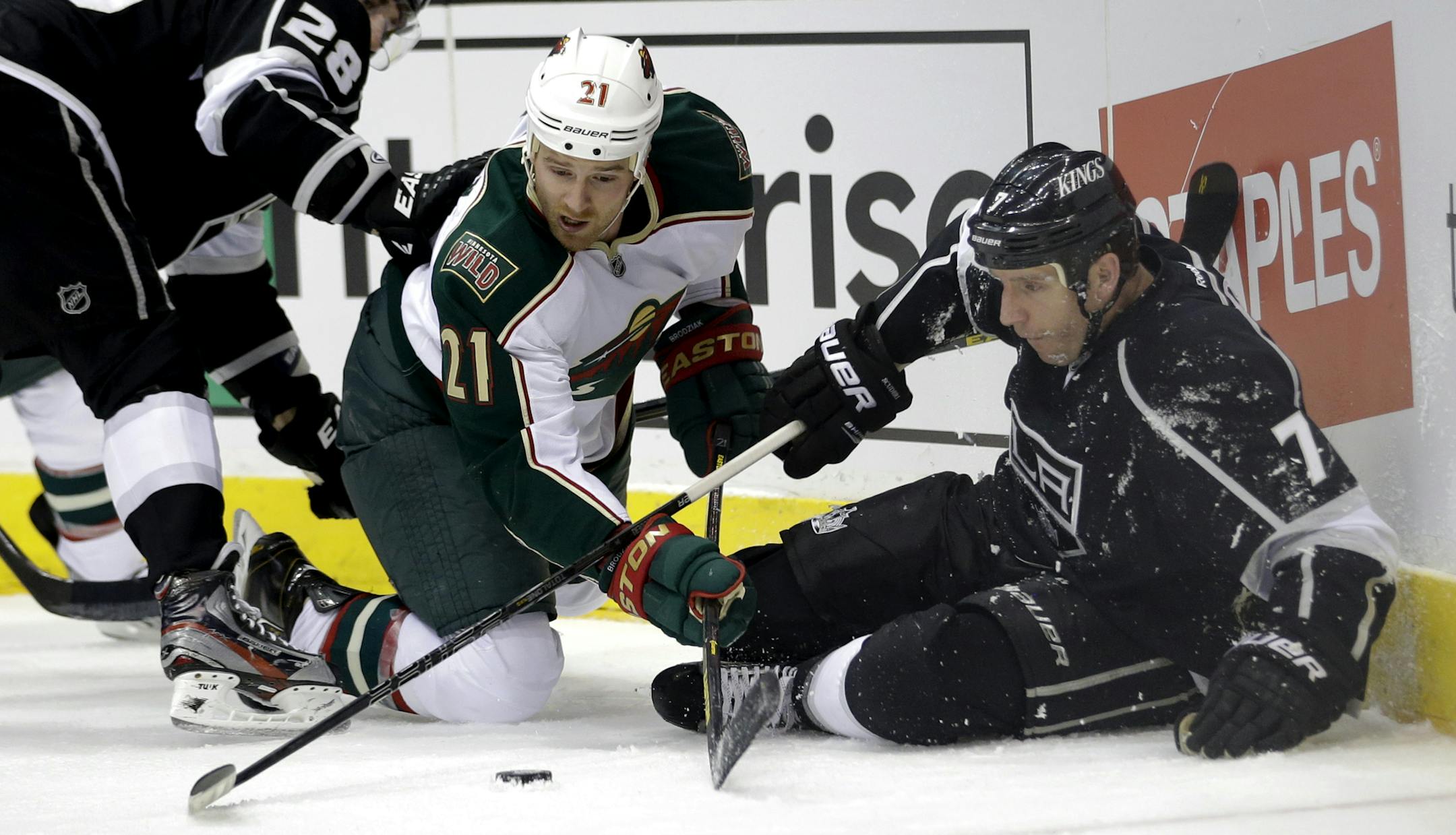 The Wild's Kyle Brodziak, left, and Los Angeles' Rob Scuderi fought for the puck during the first period.