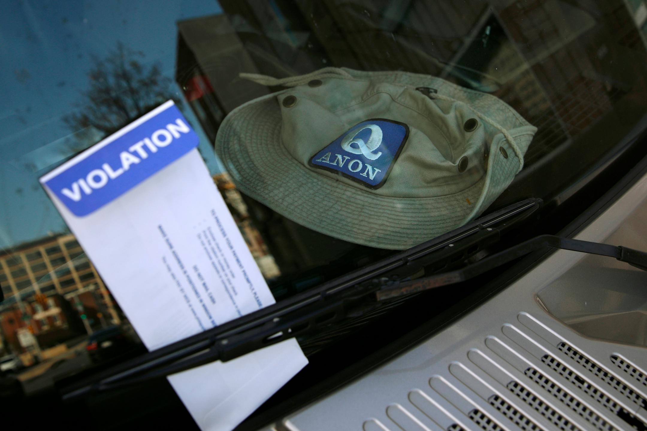 A parking violation envelope is affixed to the windshield of a Hummer vehicle parked near the Pennsylvania Convention Center where votes were being counted Friday in Philadelphia. Police said Friday they arrested two men Thursday for not having permits to carry firearms near the center. Police said the men acknowledged that the Hummer spotted by officers near the center was was their vehicle.